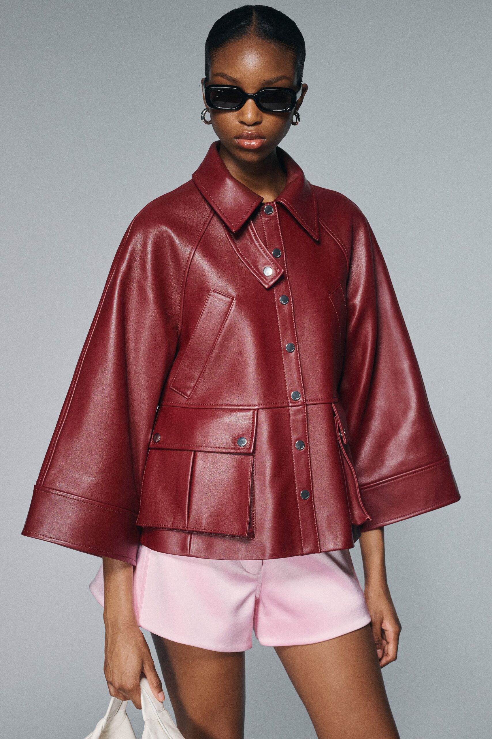 red leather long-sleeve collared relaxed buttoned pockets jacket