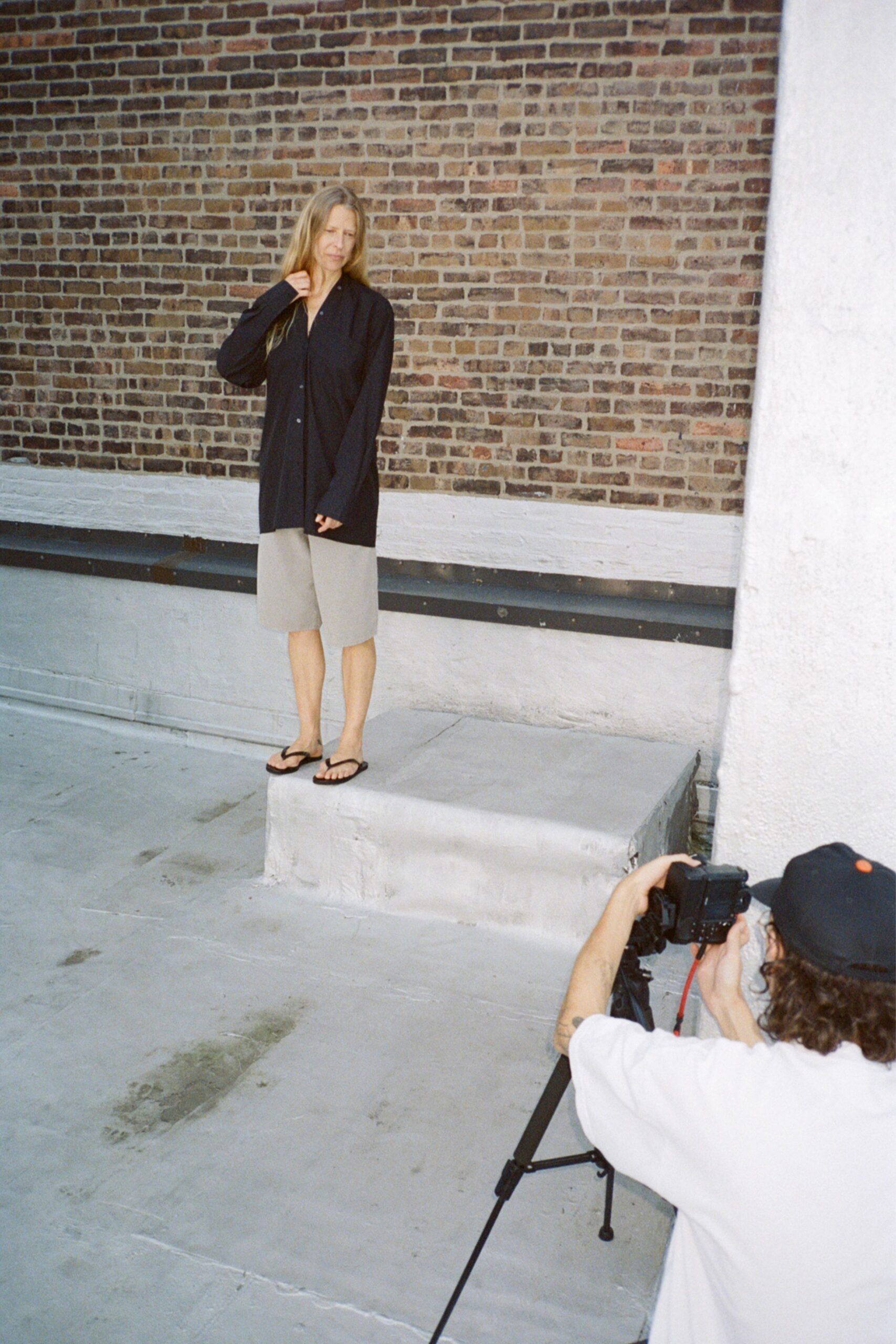 black shirt gray shorts sandals