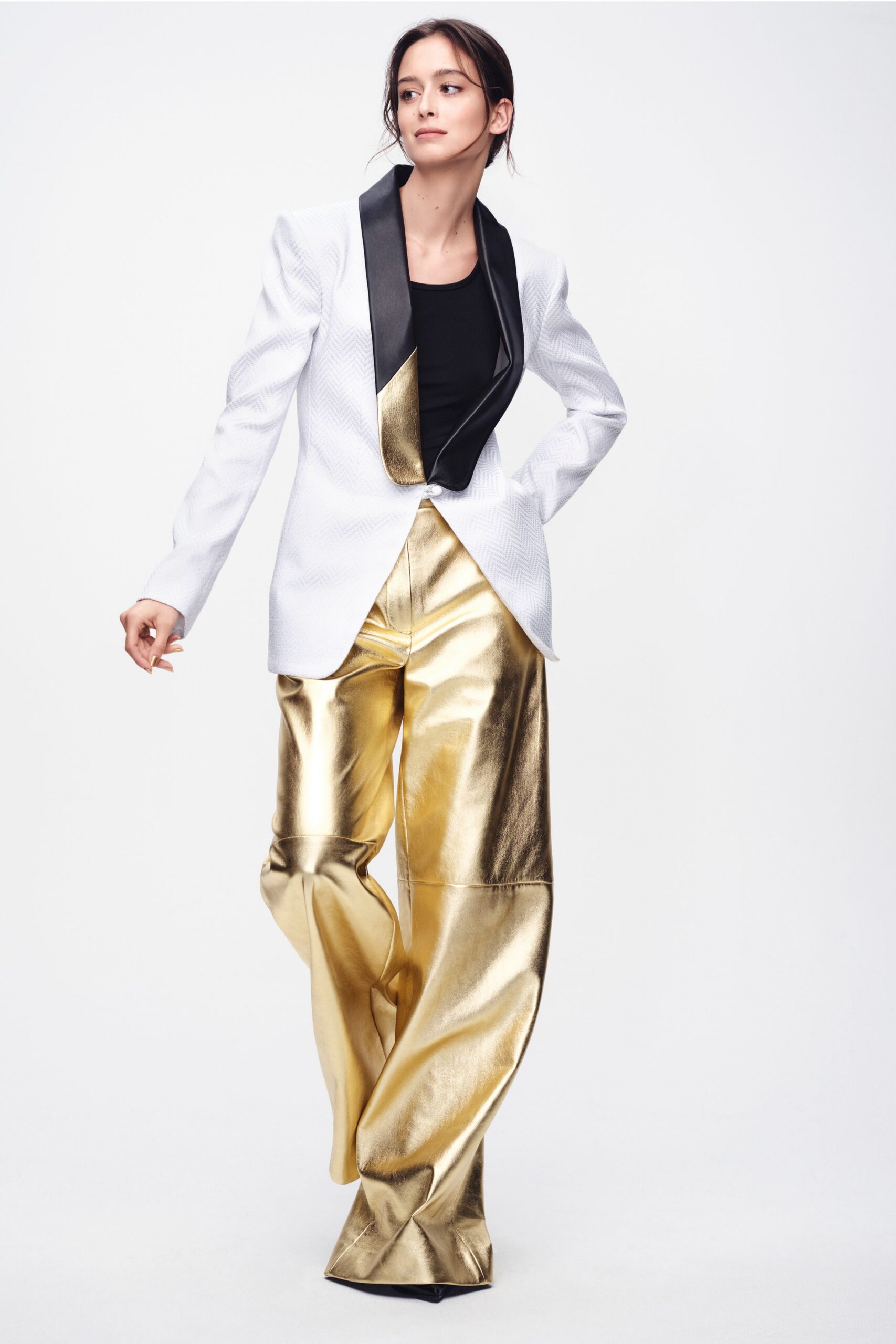 white tailored blazer black top gold pants