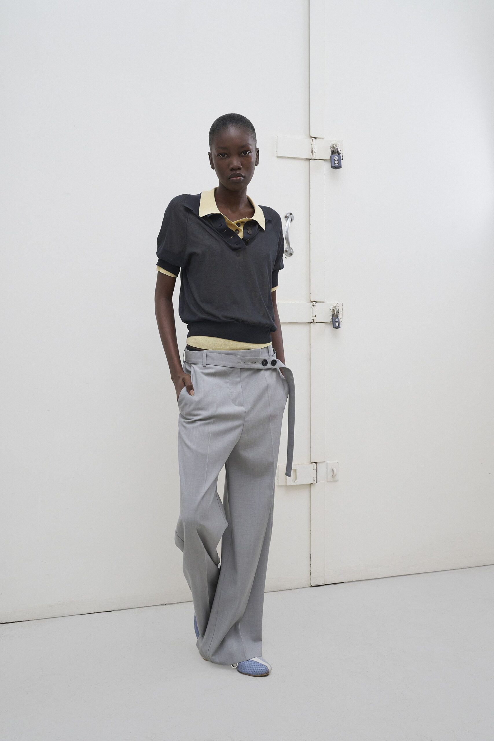 black and yellow fitted top with gray pants