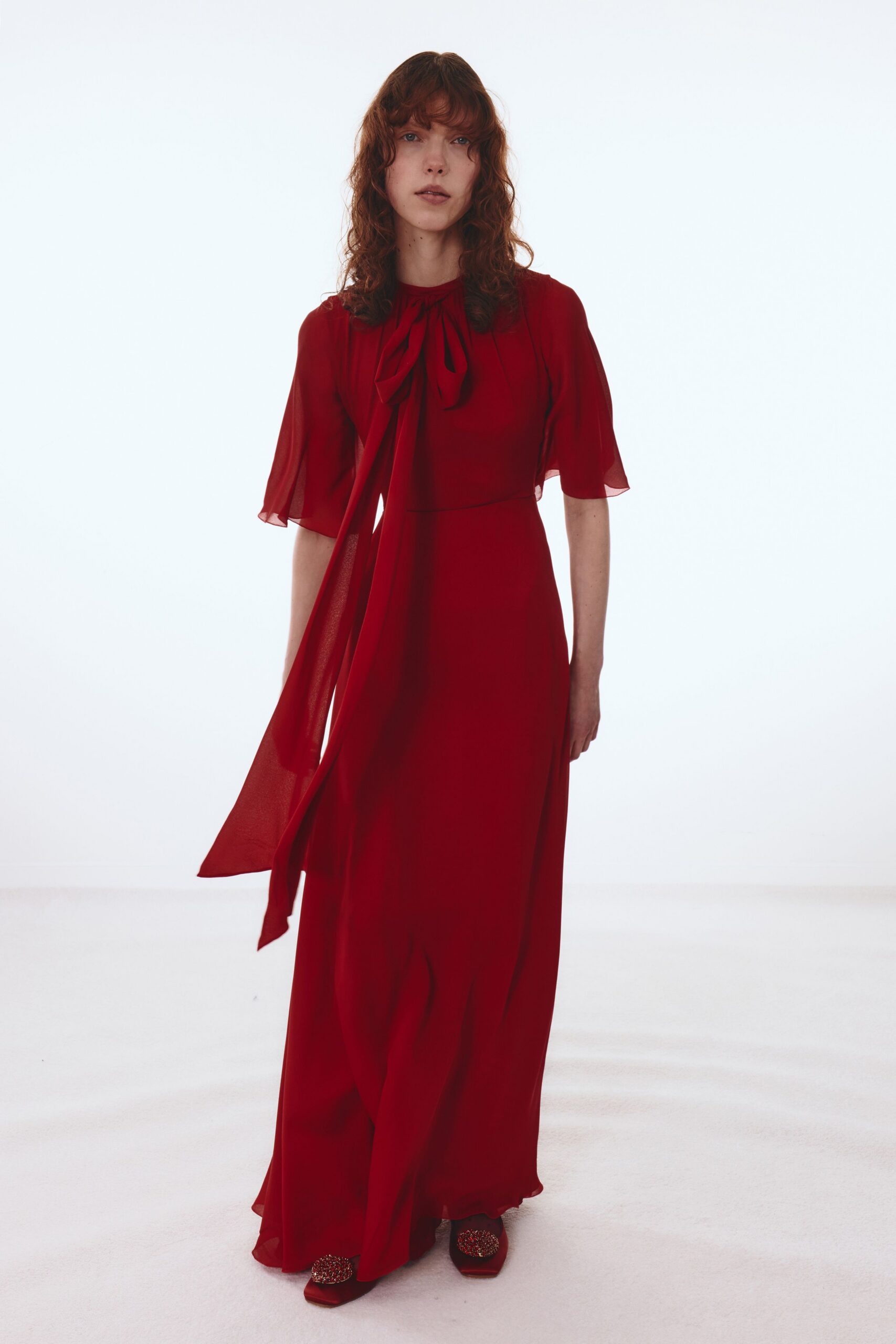 red silk gown with embellished shoes
