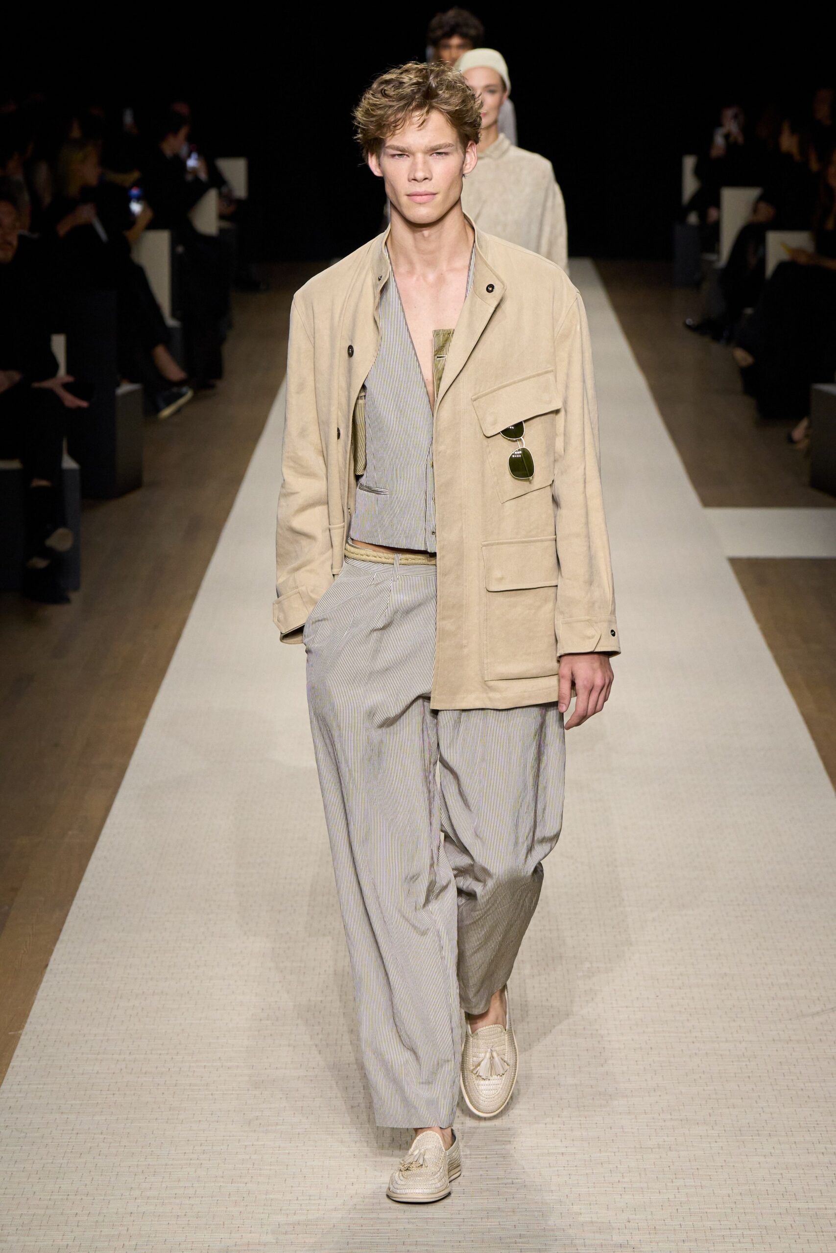beige jacket gray jumpsuit white shoes