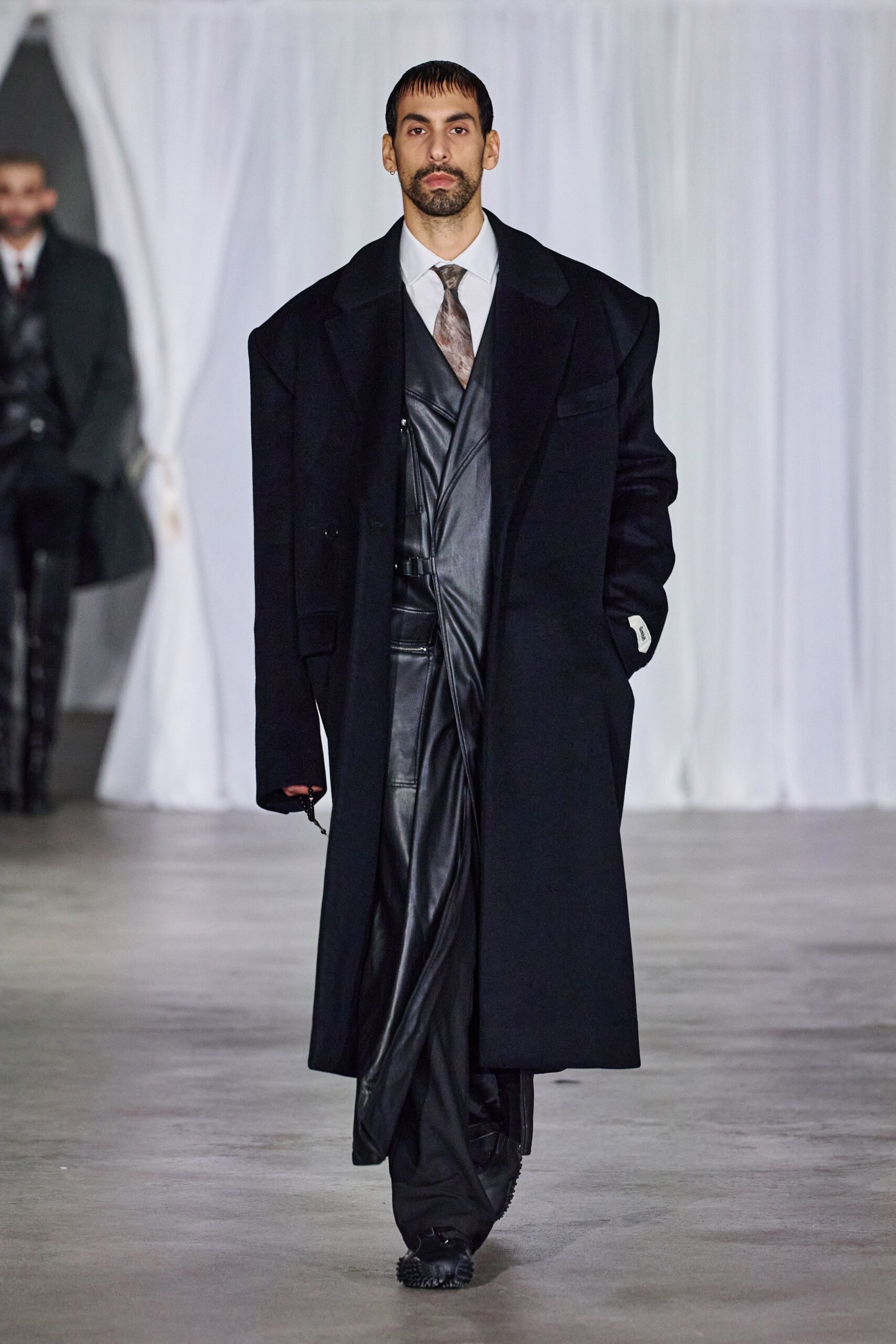 black oversized coat with leather vest