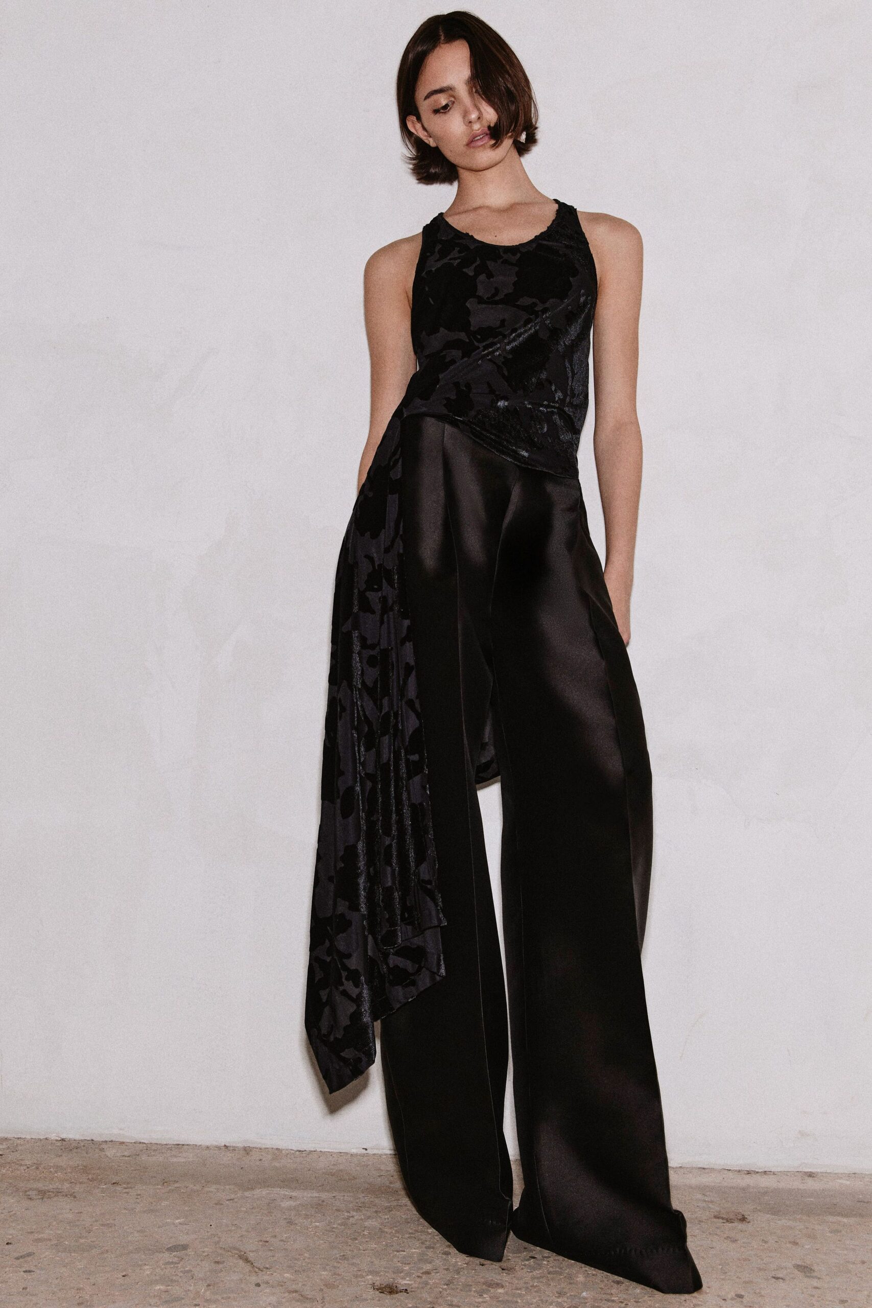 black silk sleeveless top and wide-leg pants
