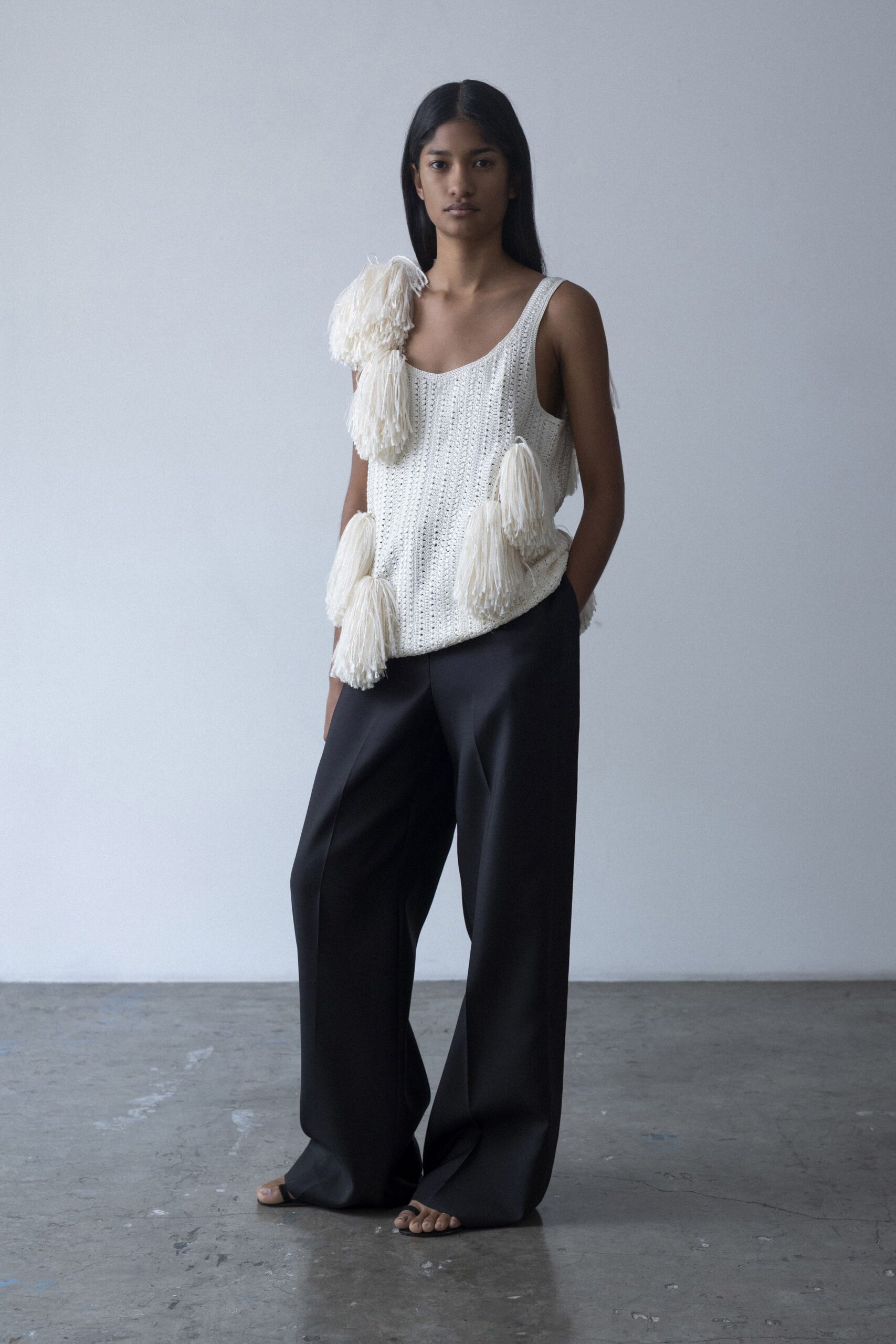 white fringed top with black pants