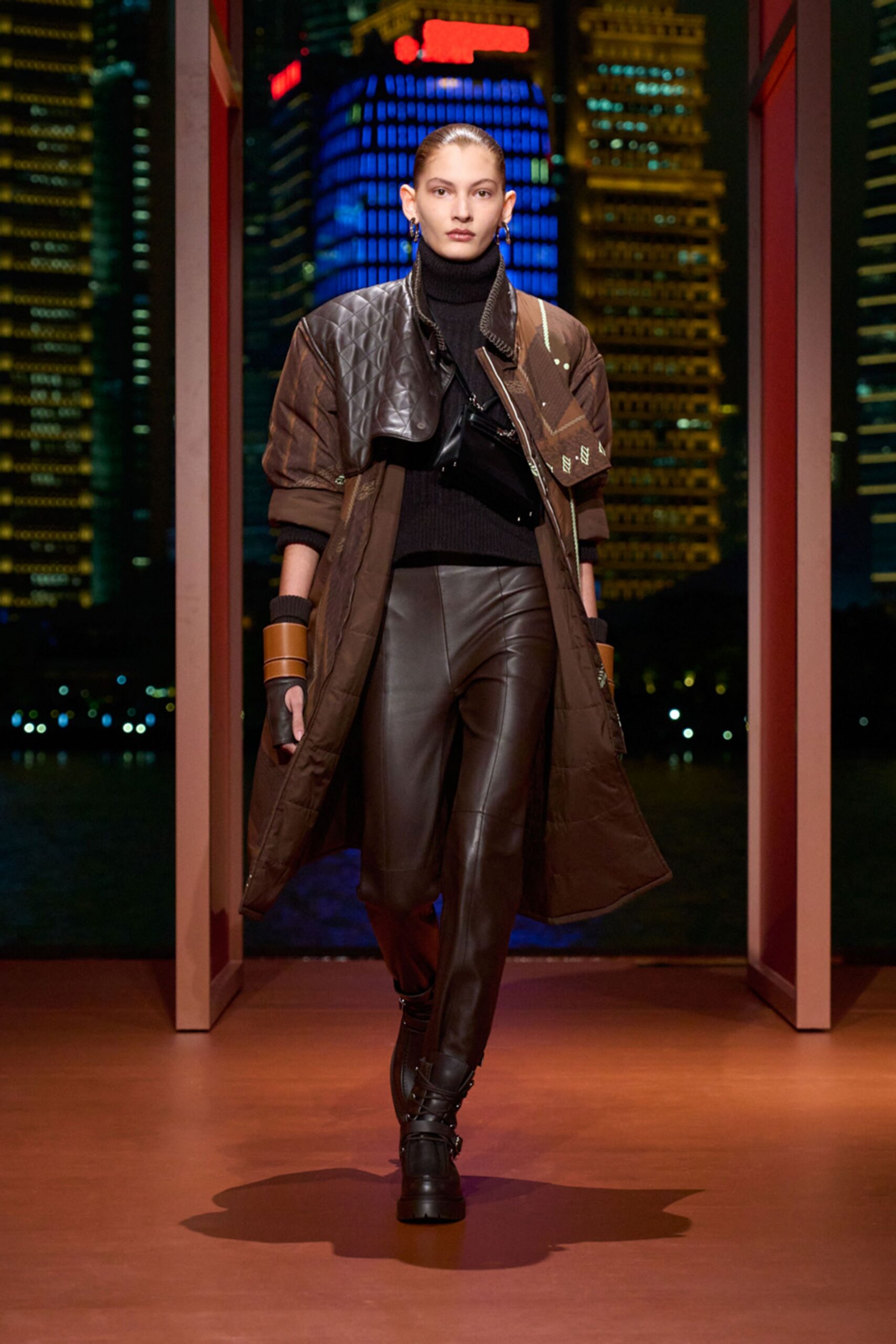 brown leather quilted coat with black top and pants