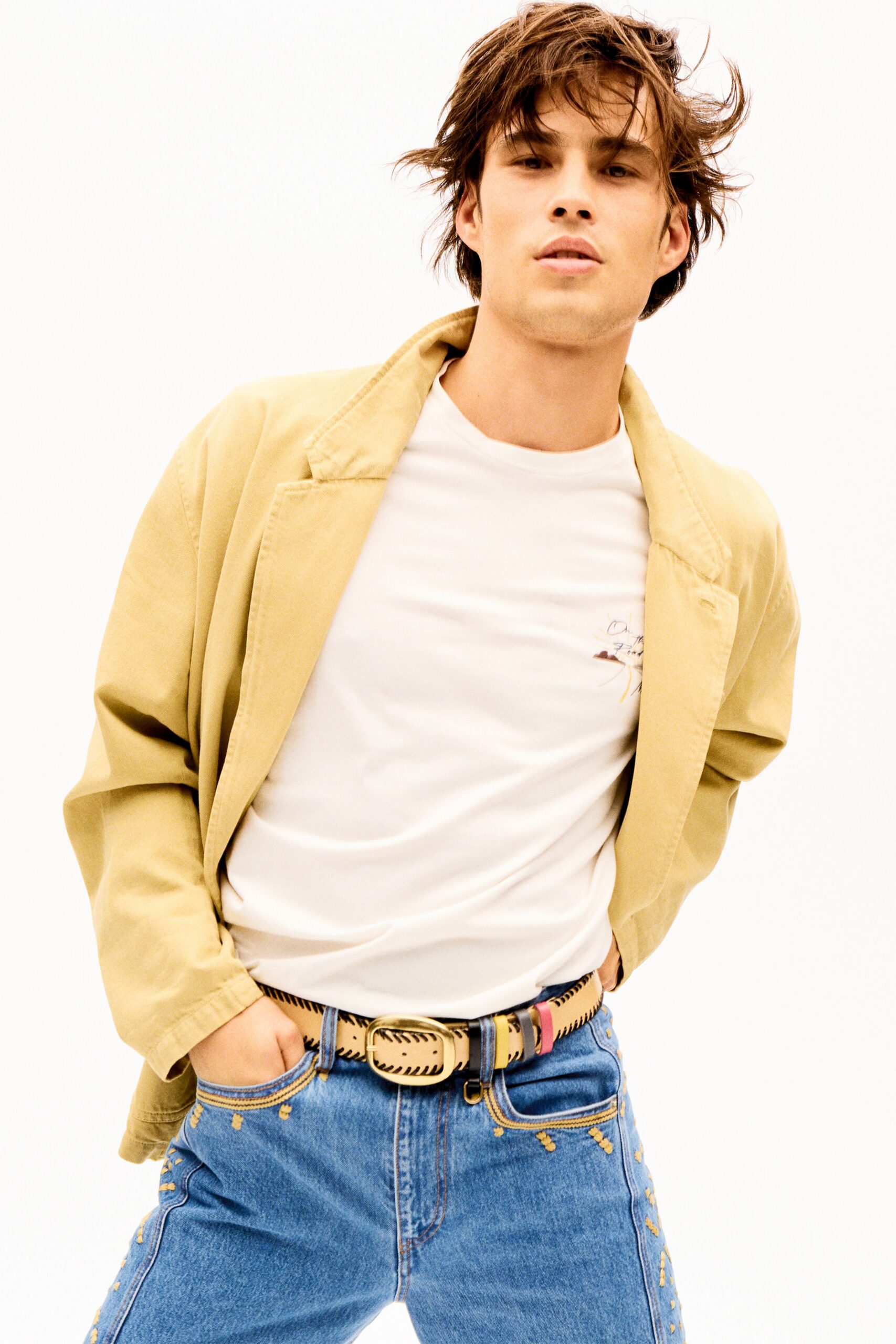 beige jacket white t-shirt blue jeans