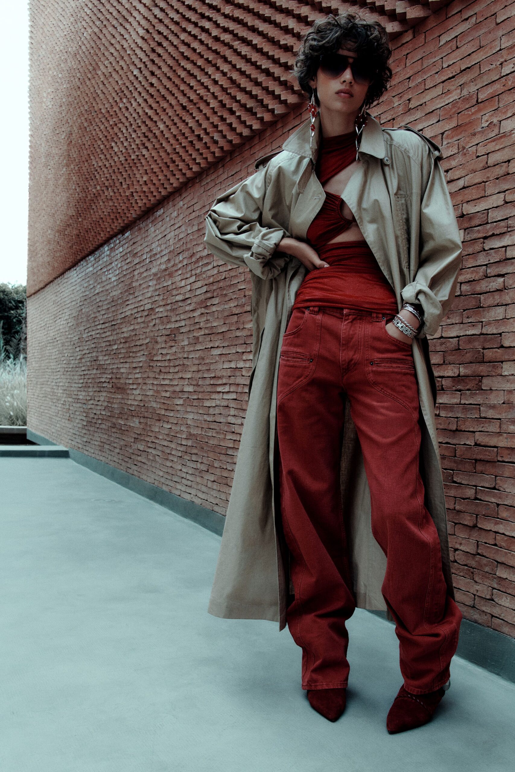 beige trench coat red top and pants