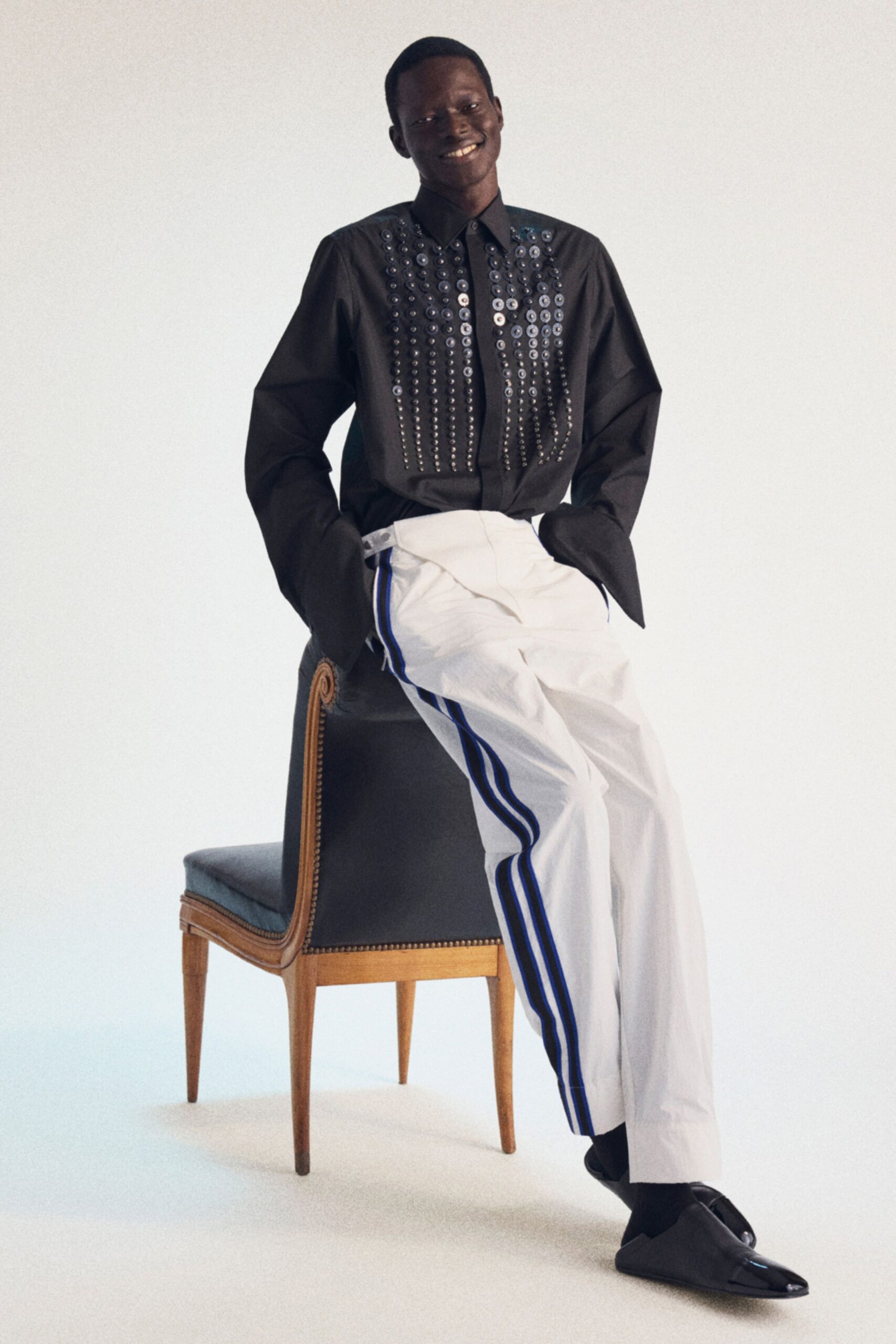 black shirt white tailored pants