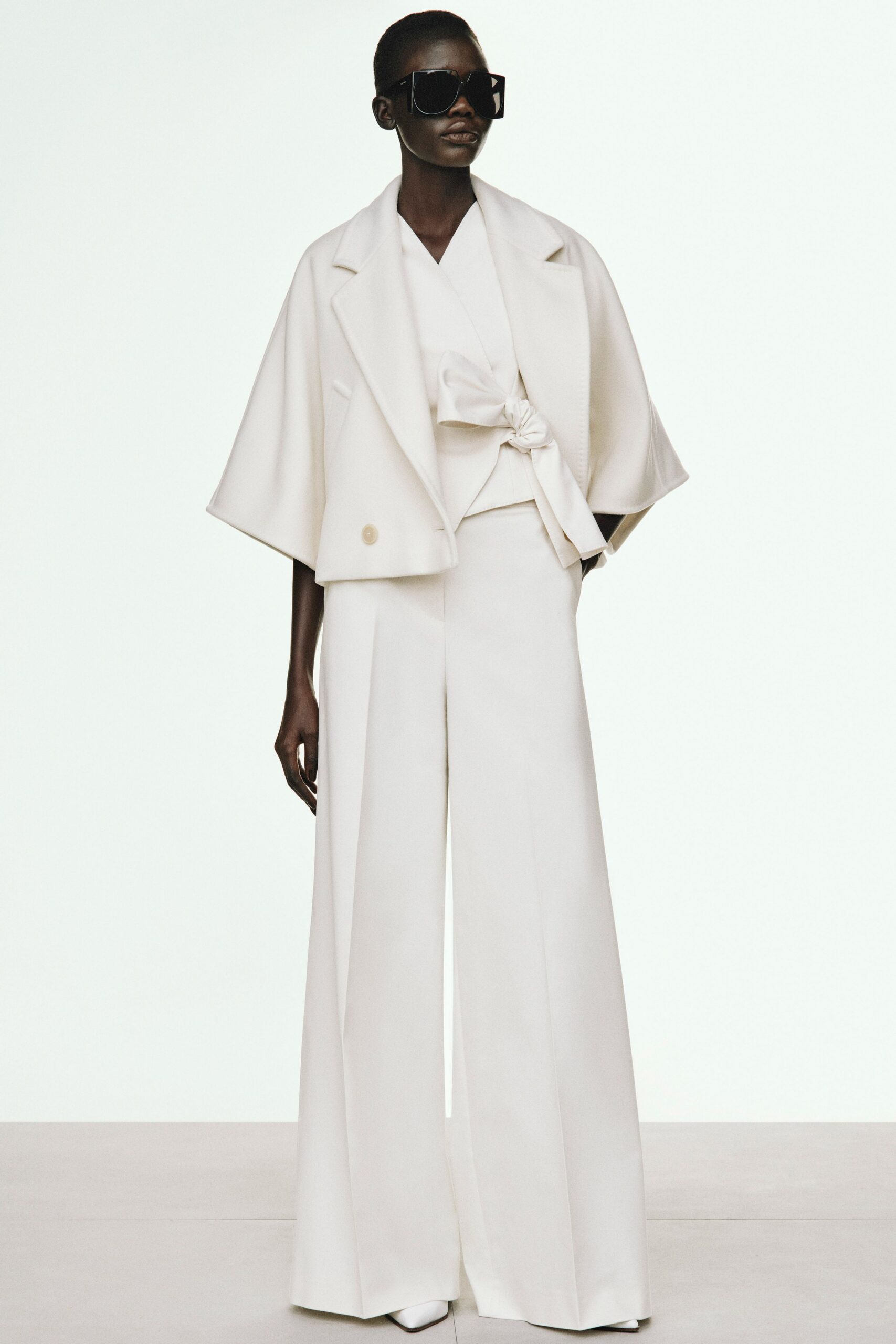 white tailored outfit with sunglasses