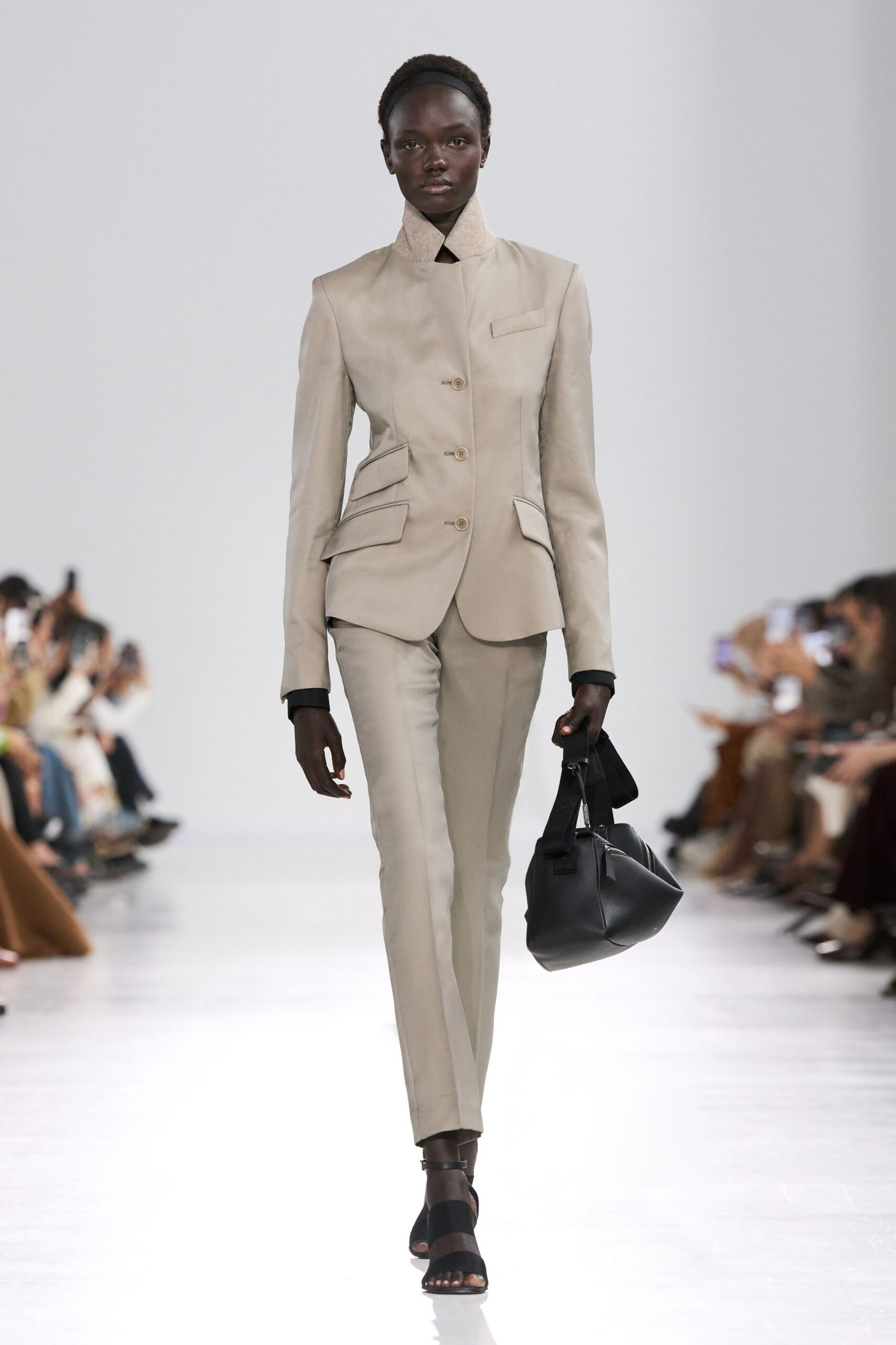 beige tailored suit with black accessories