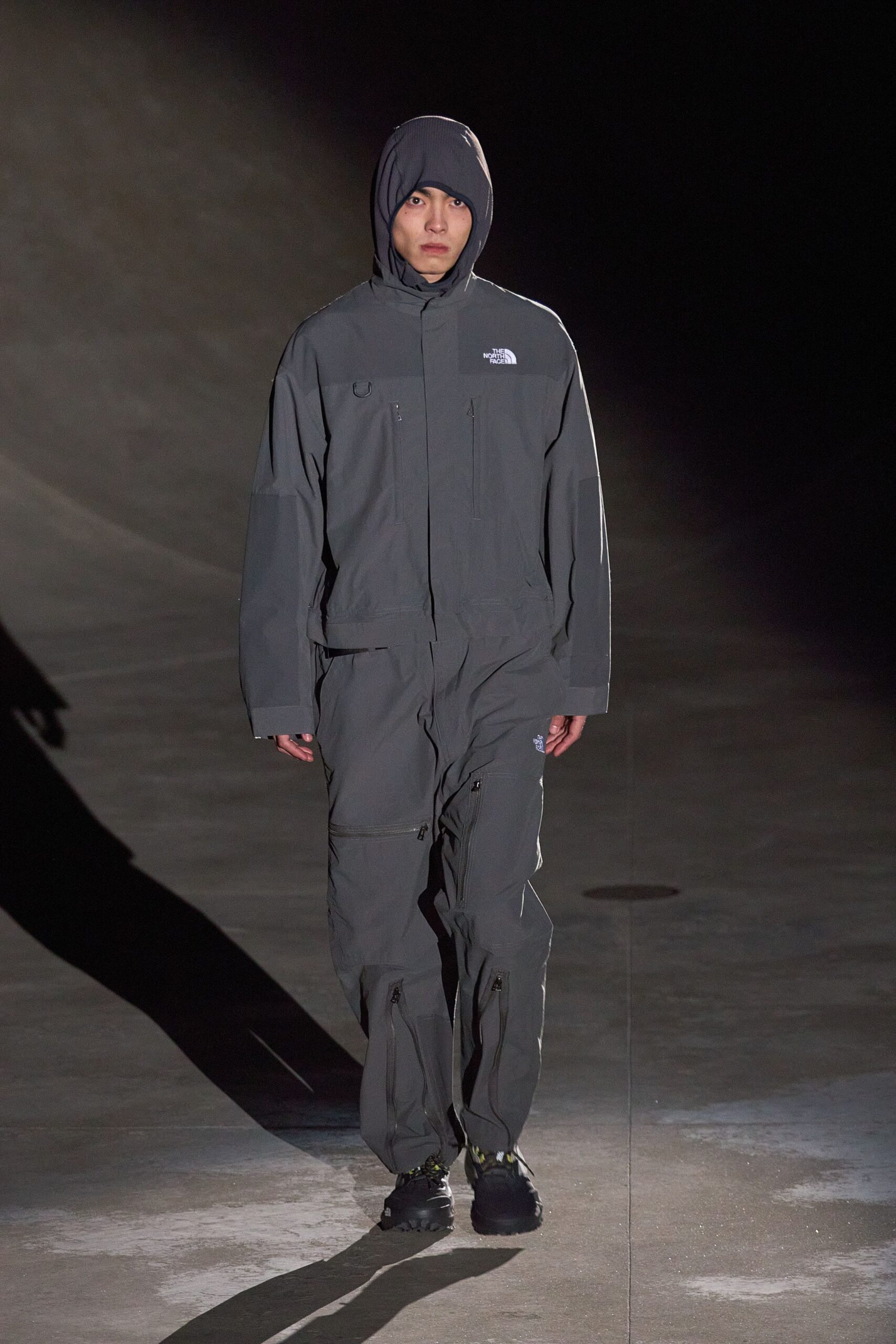 gray hooded jumpsuit with black shoes