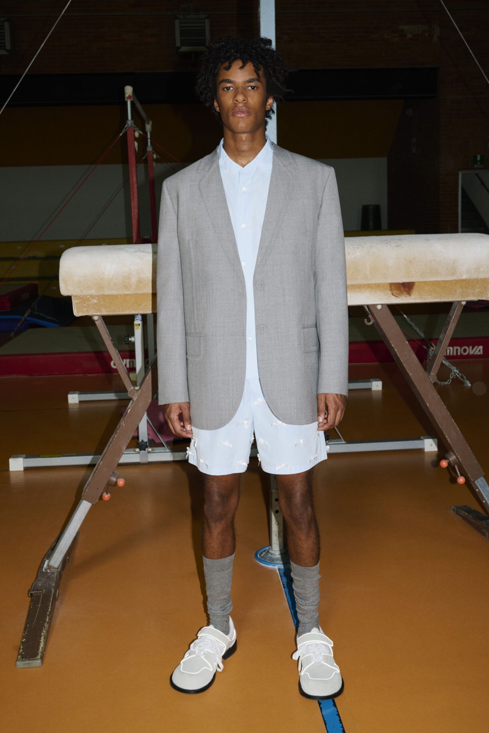 gray tailored blazer with white shirt and shorts