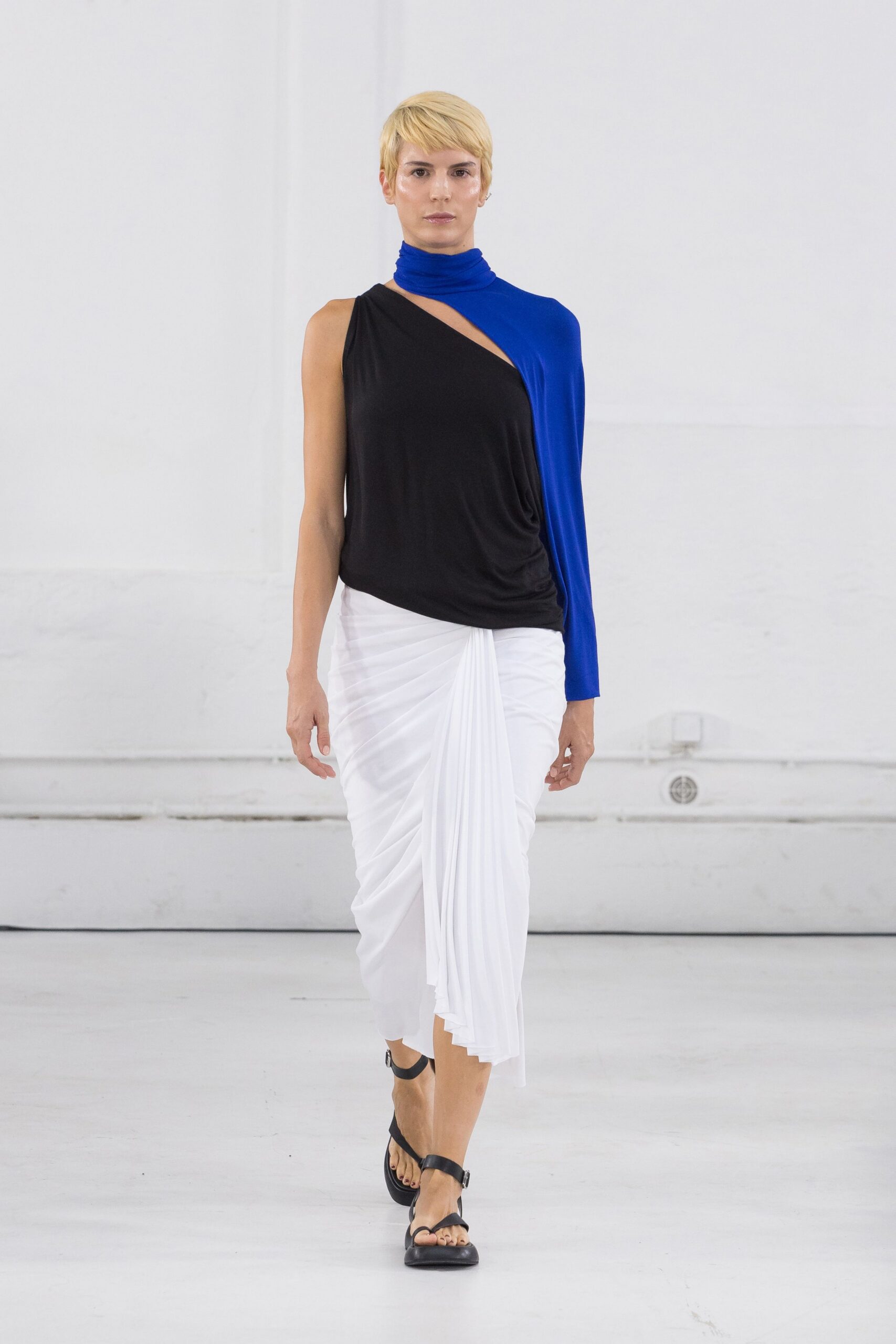 black and blue asymmetric top with pleated skirt