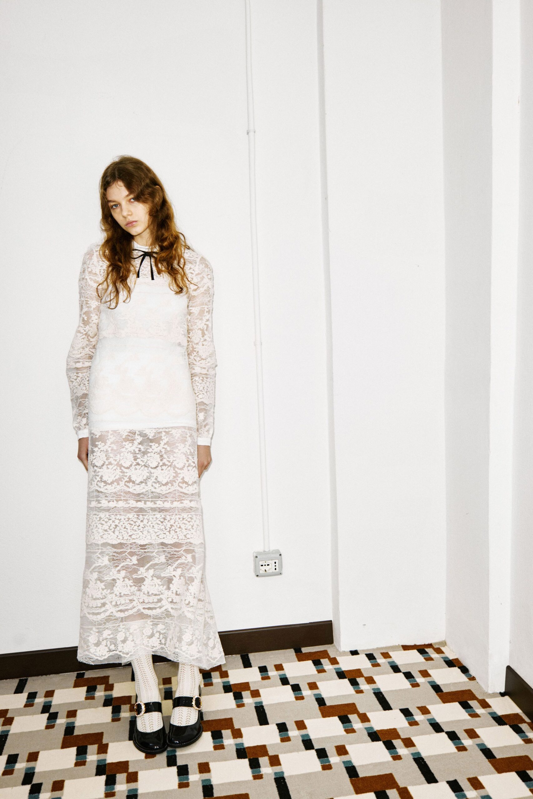 white lace fitted gown with black shoes