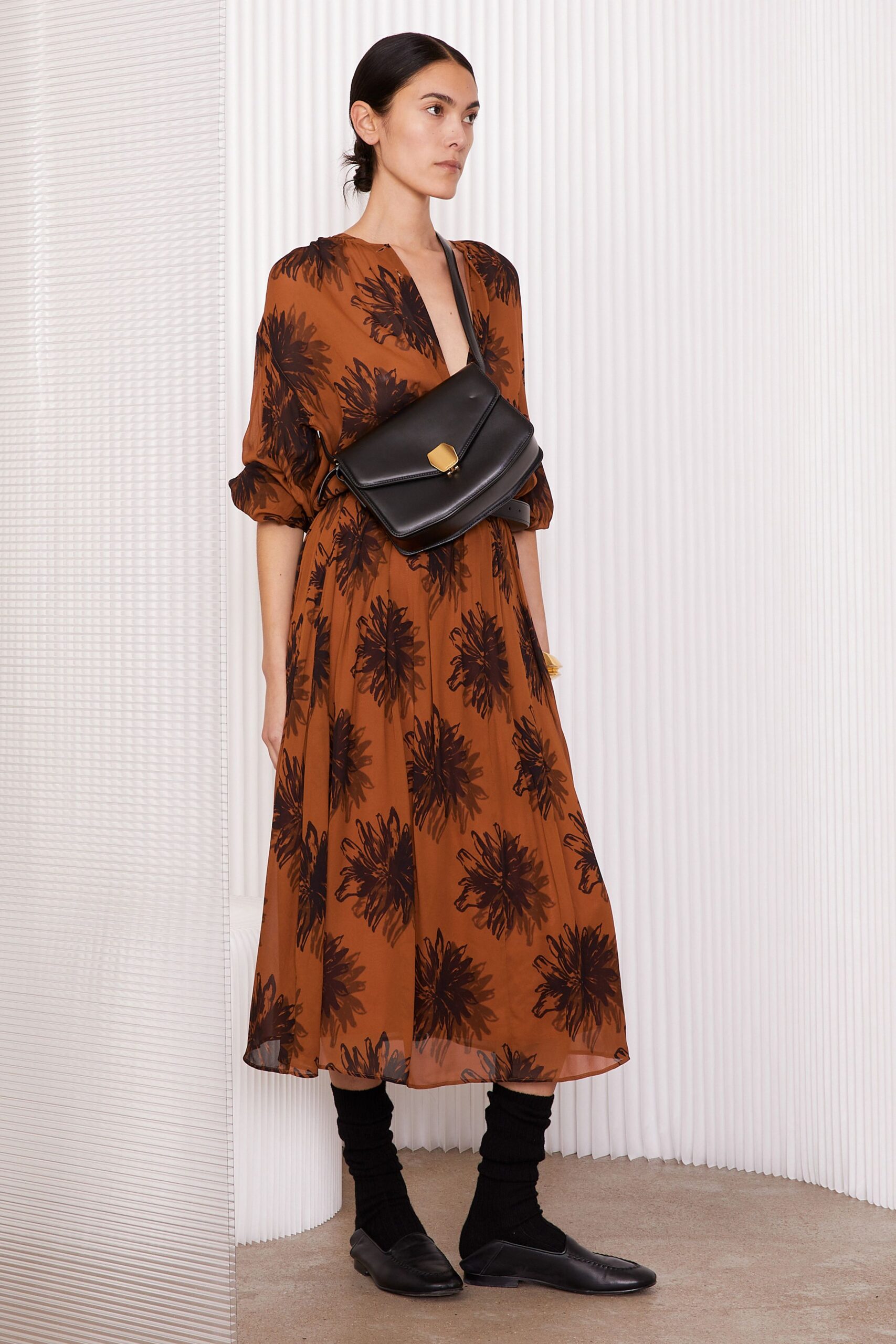 brown floral midi dress with black bag