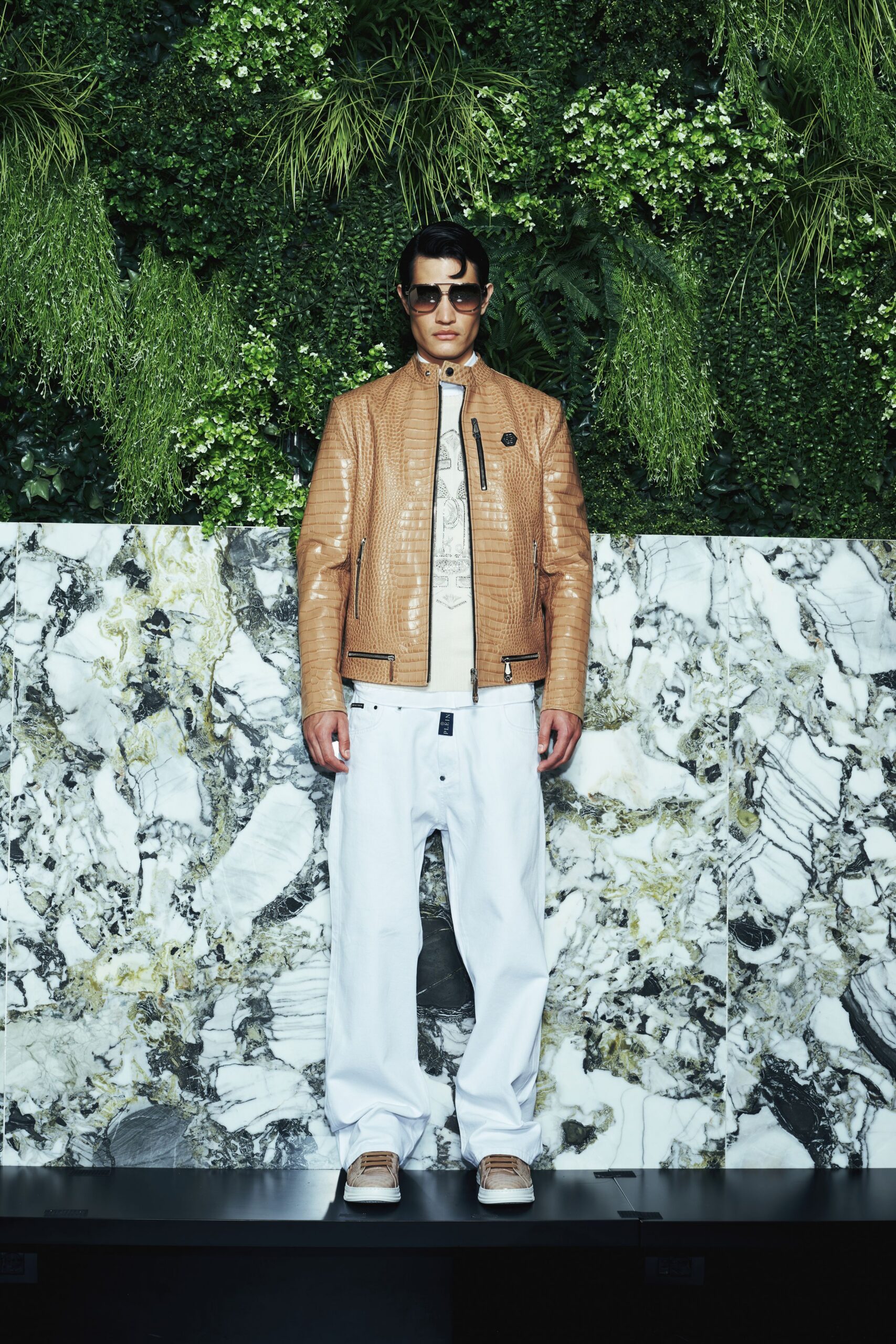 brown leather jacket with white pants