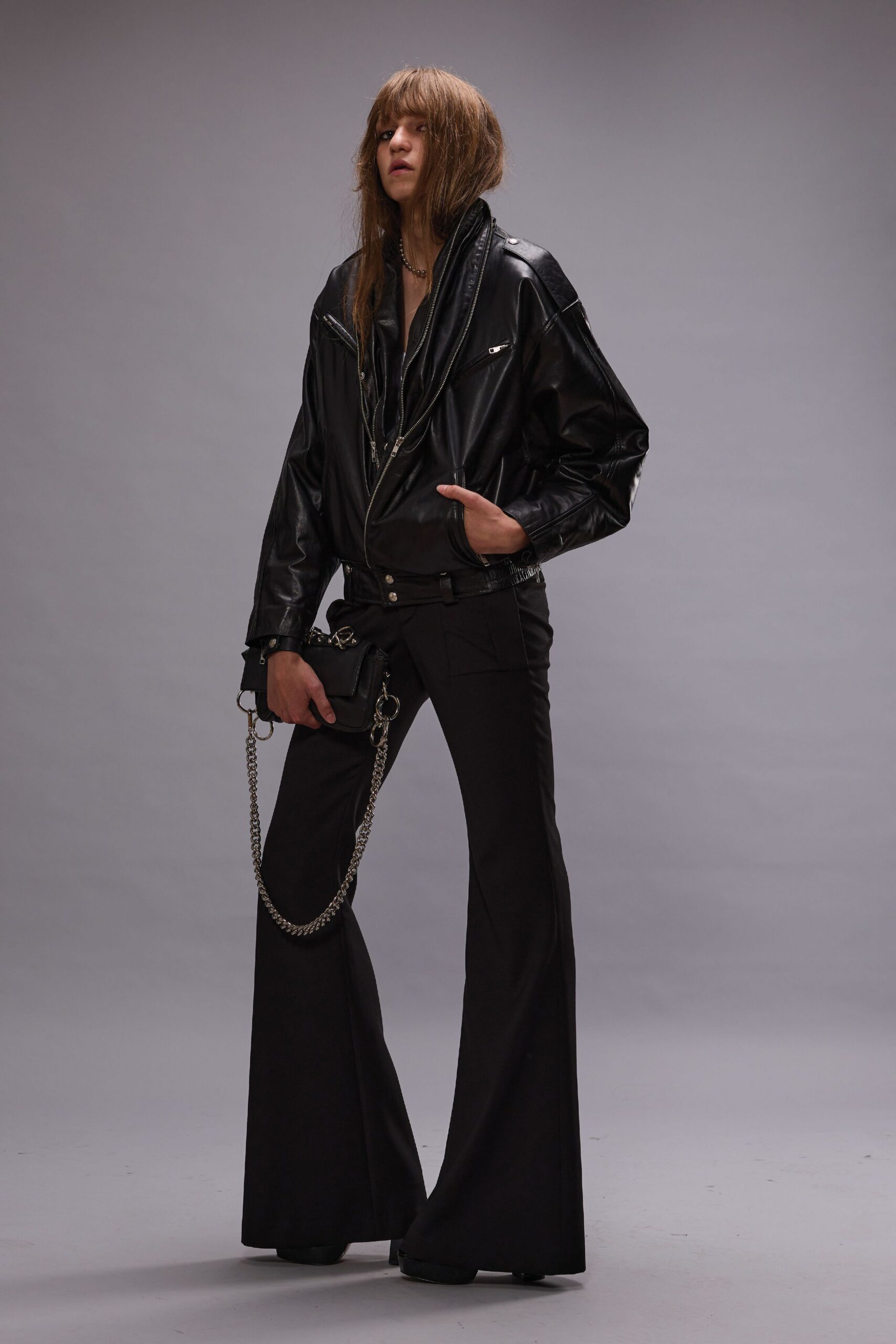 black leather oversized jacket and flared pants