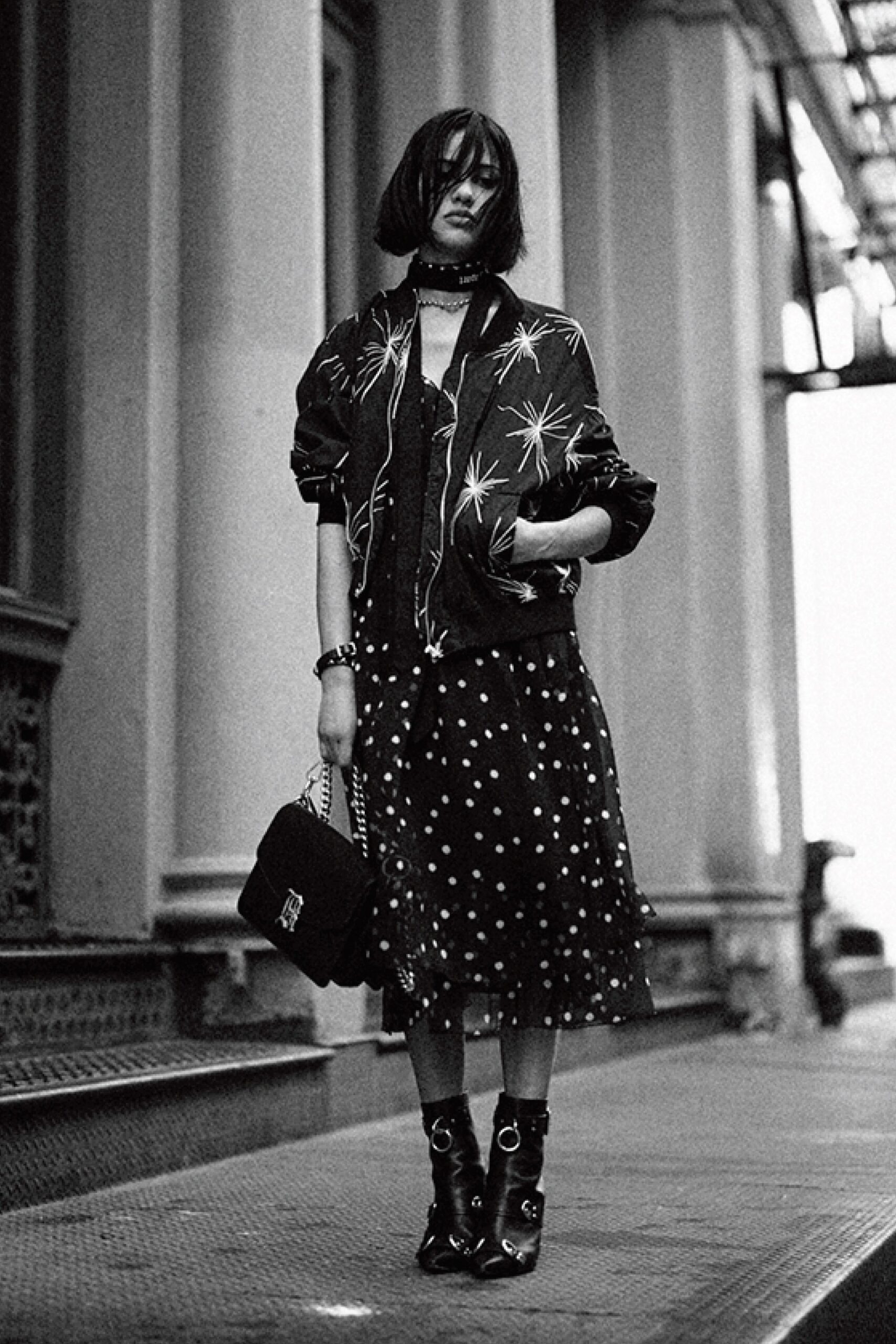 black jacket over black polka-dot dress
