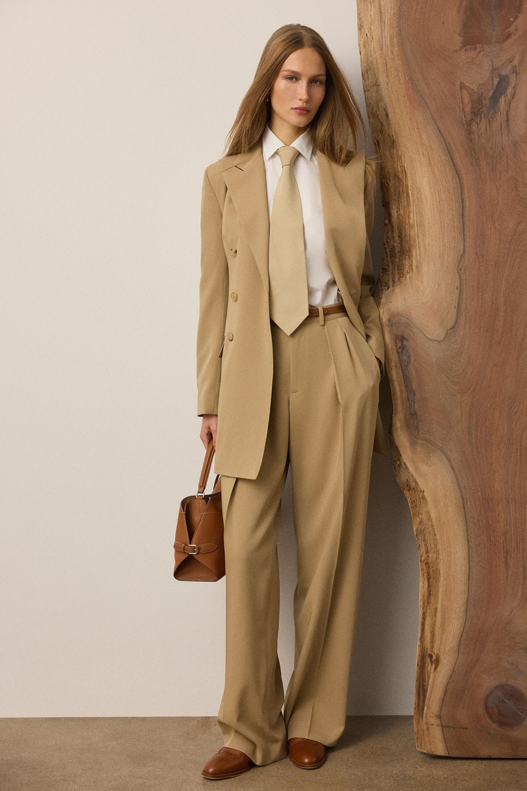 beige tailored suit with brown accessories