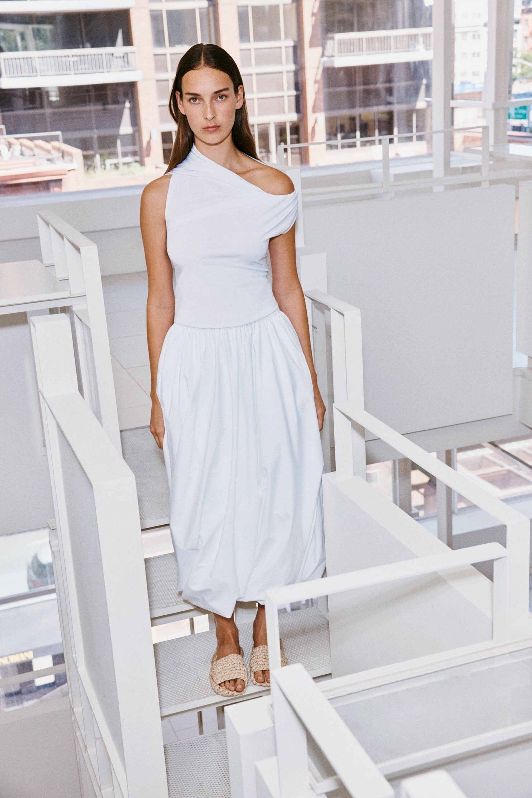 white cotton sleeveless off-shoulder fitted pleated draped dress
