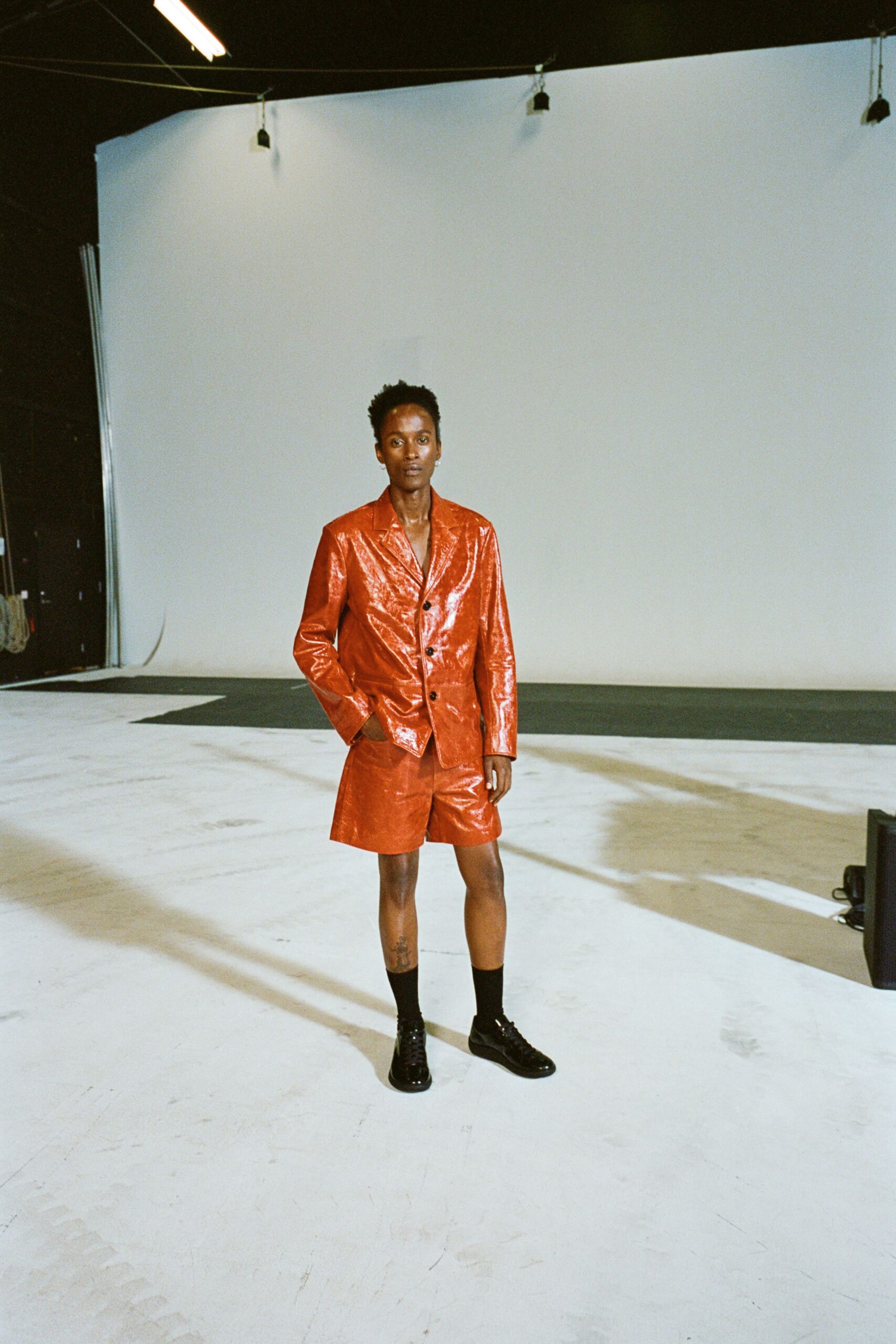 red vinyl short-sleeve collared fitted buttoned shiny suit