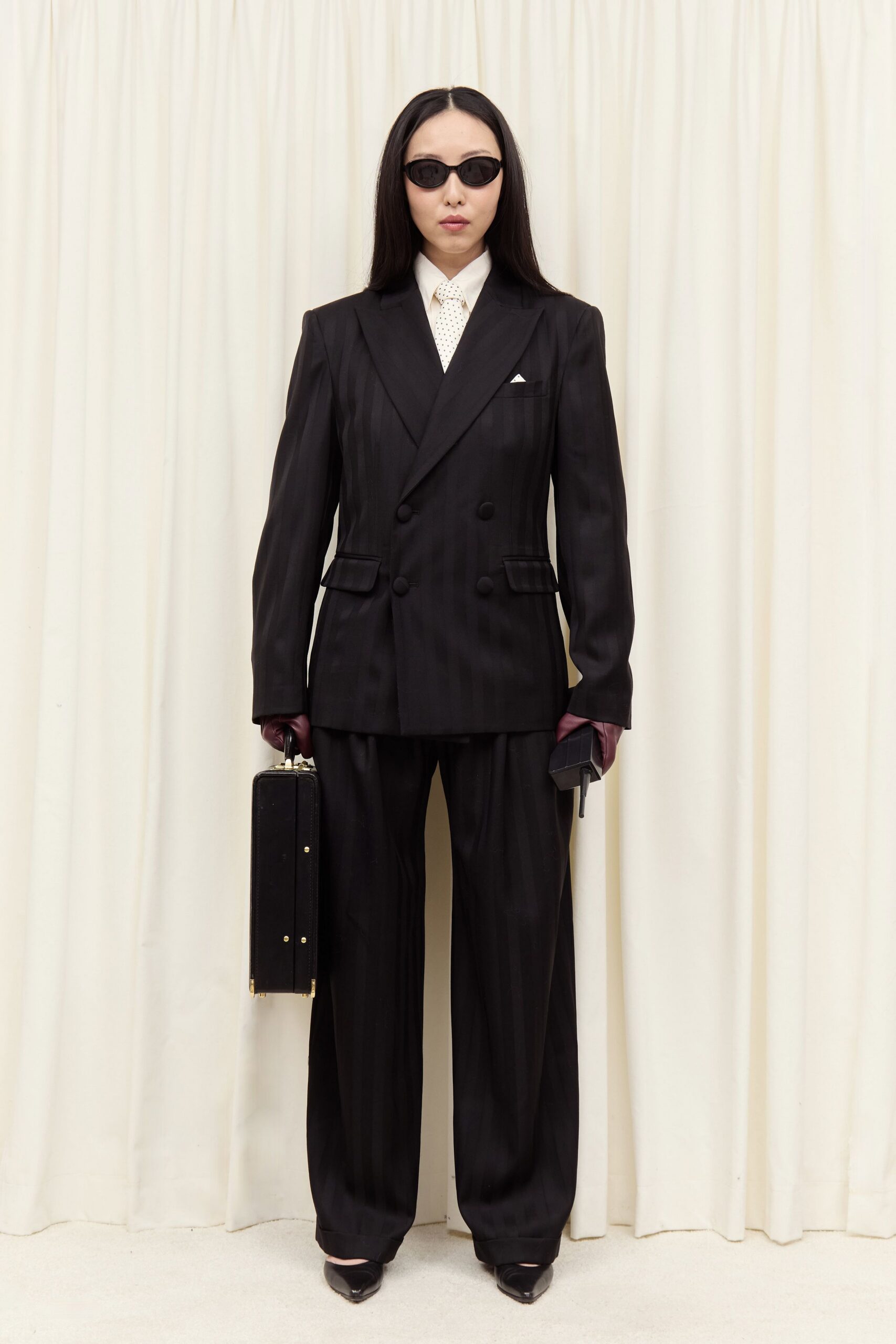 black tailored suit with sunglasses
