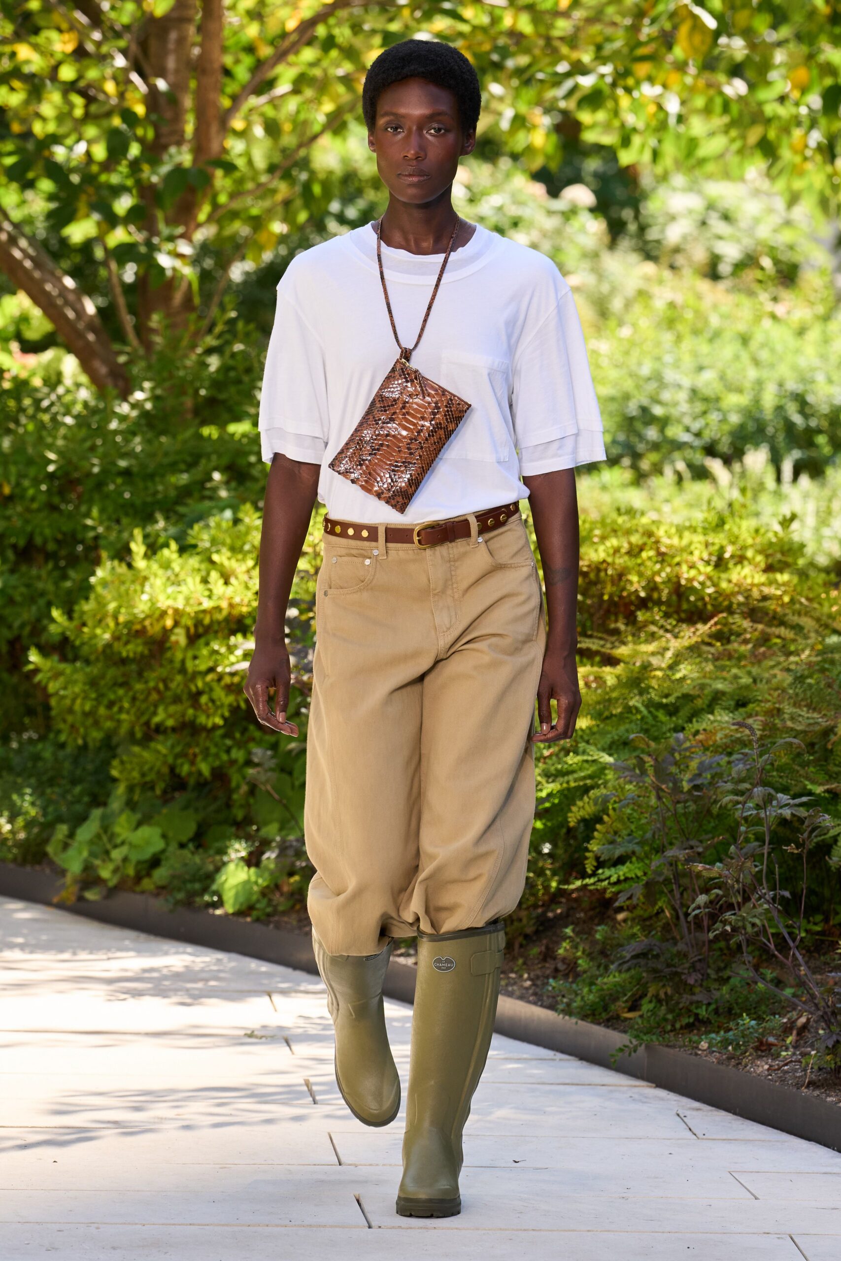 white t-shirt beige pants green boots