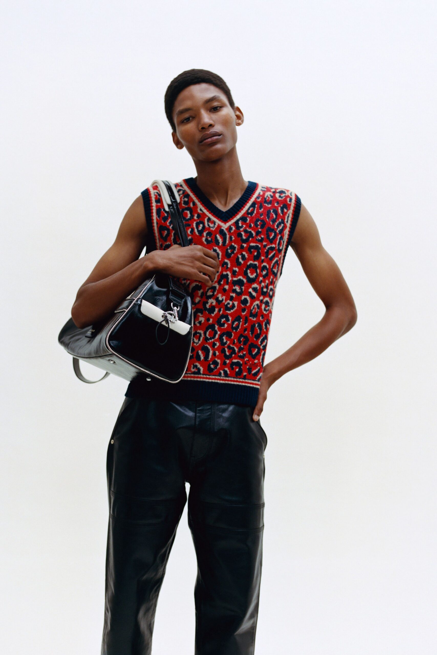 red printed vest with black leather pants