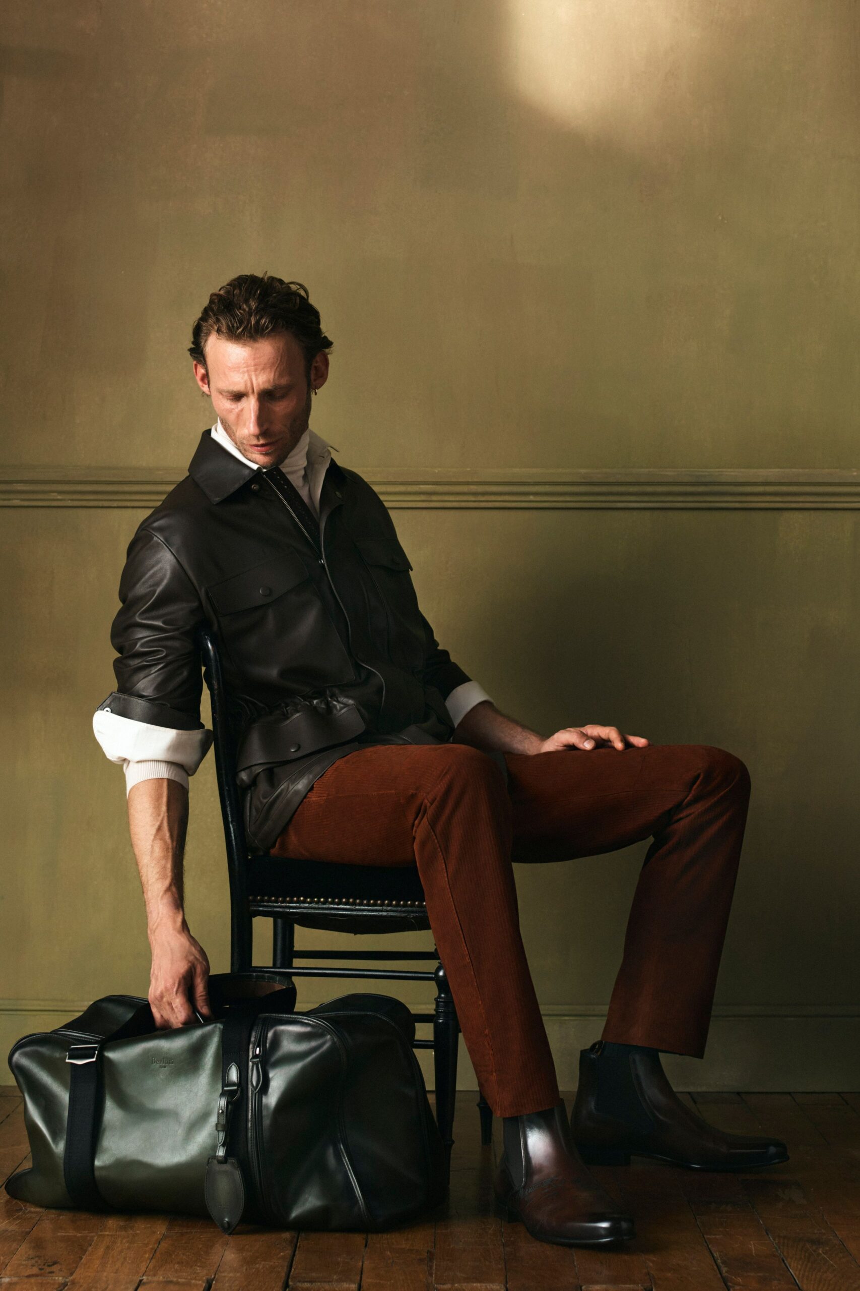 black leather jacket with brown pants