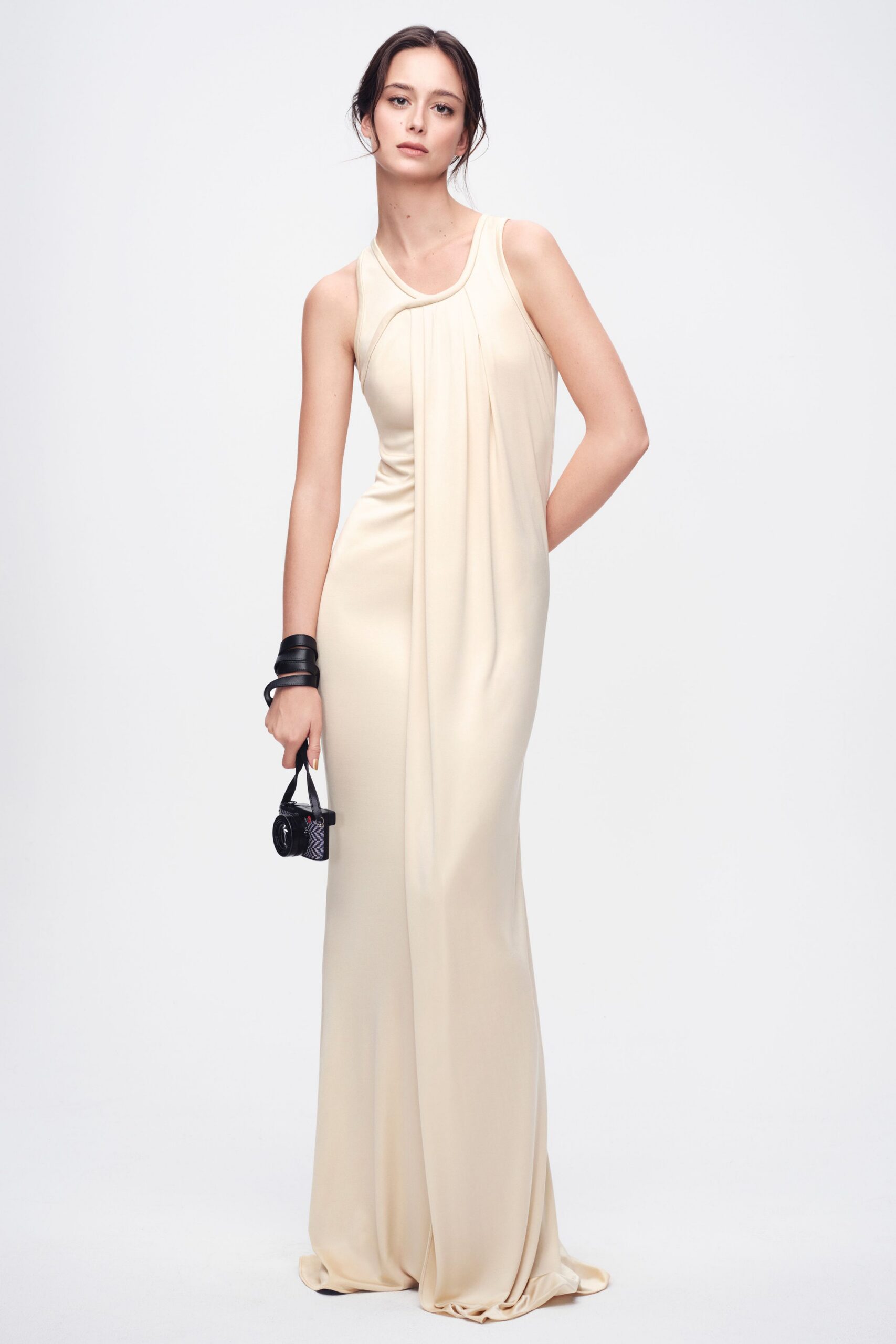 beige silk sleeveless high-neck fitted draped flowing gown