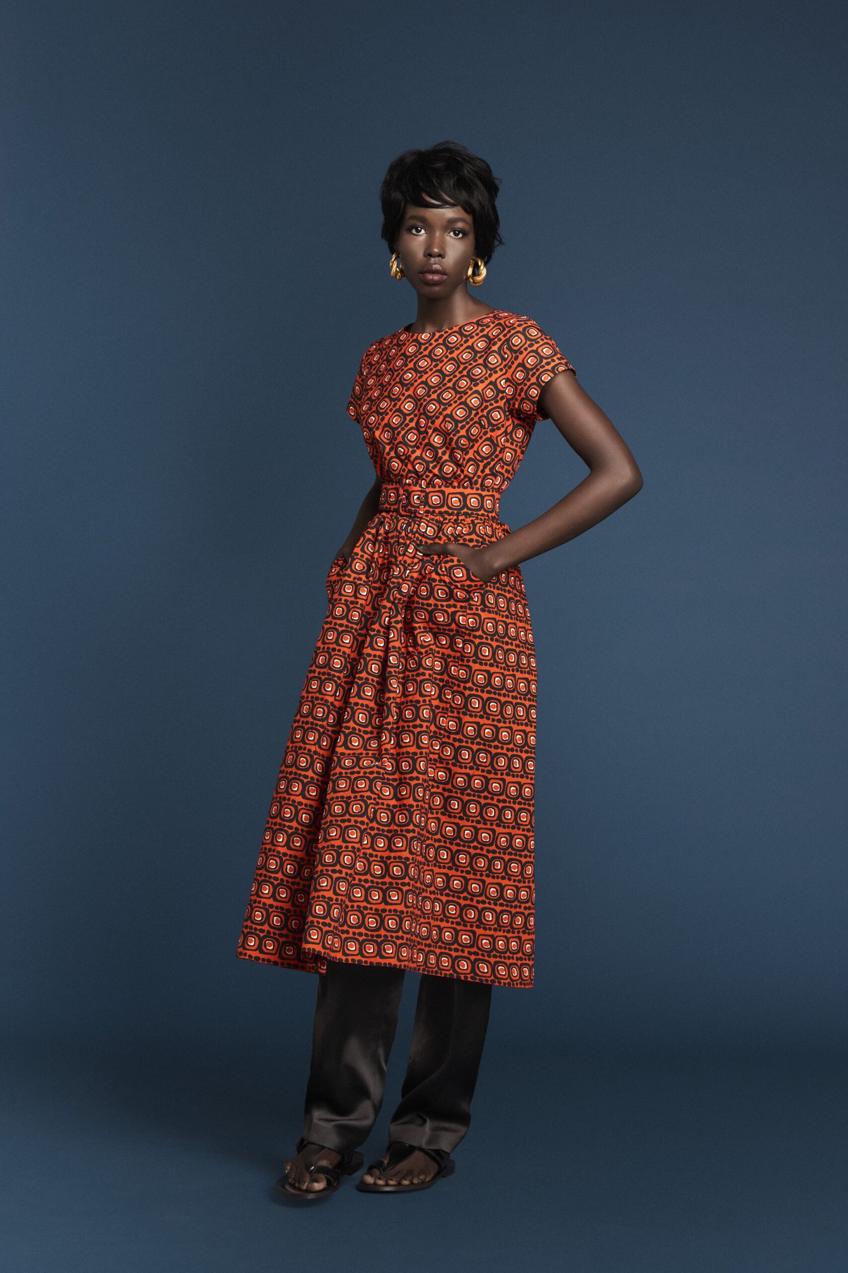 red printed midi dress with black pants