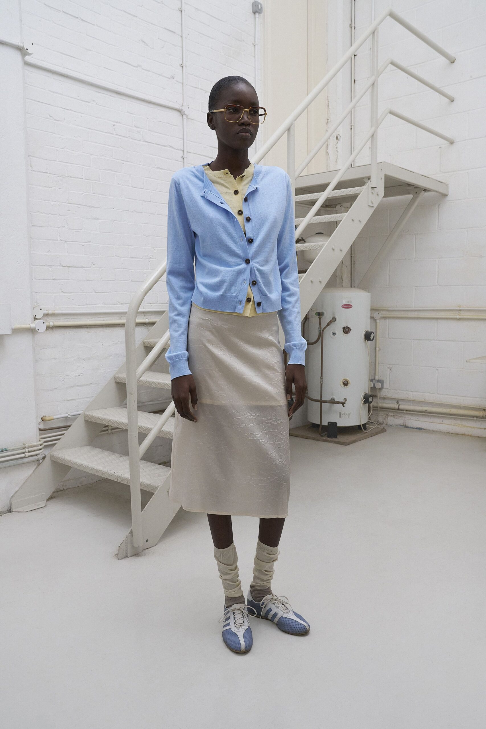 blue cardigan yellow top beige skirt