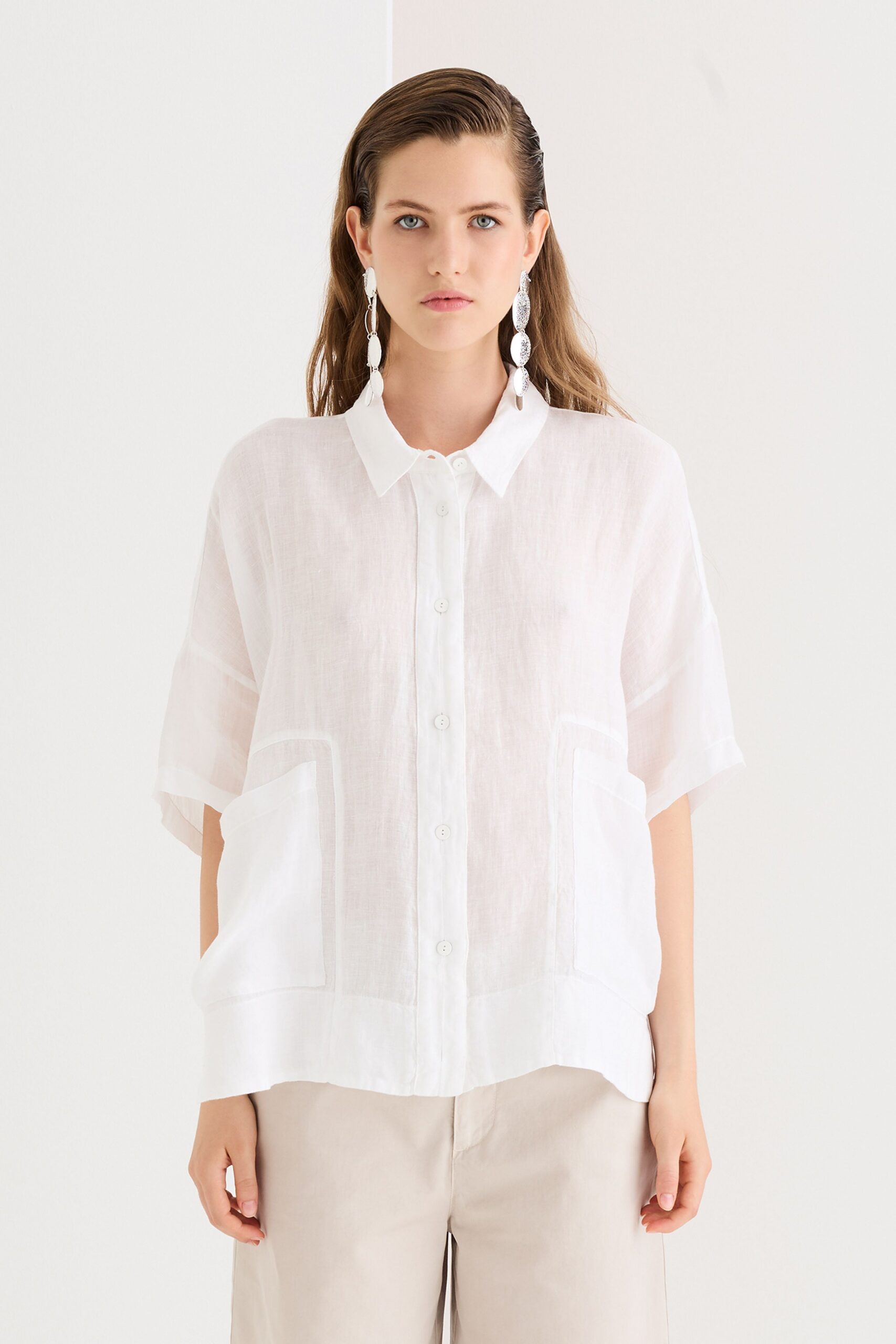 white relaxed shirt and beige pants