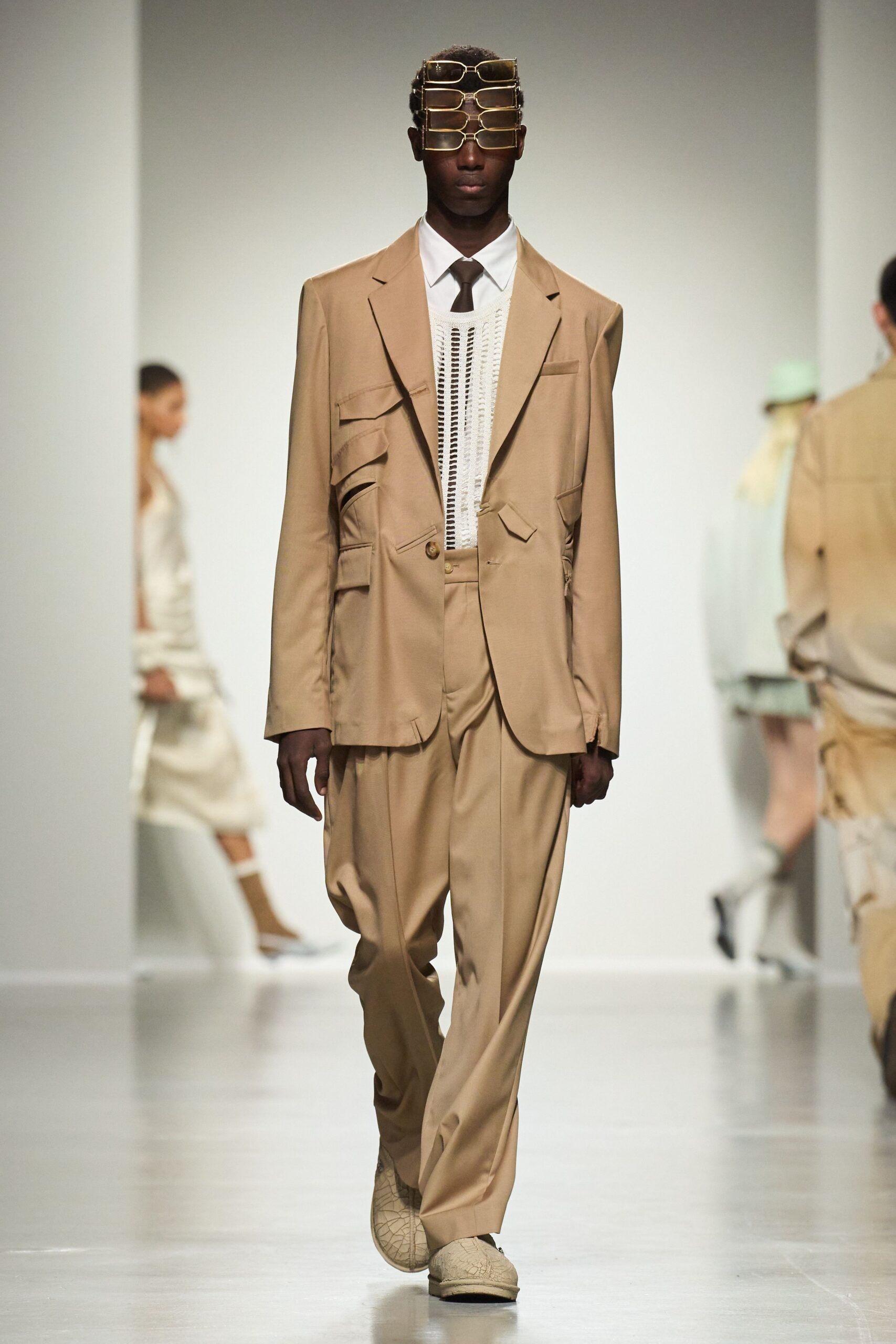 beige relaxed suit with sunglasses
