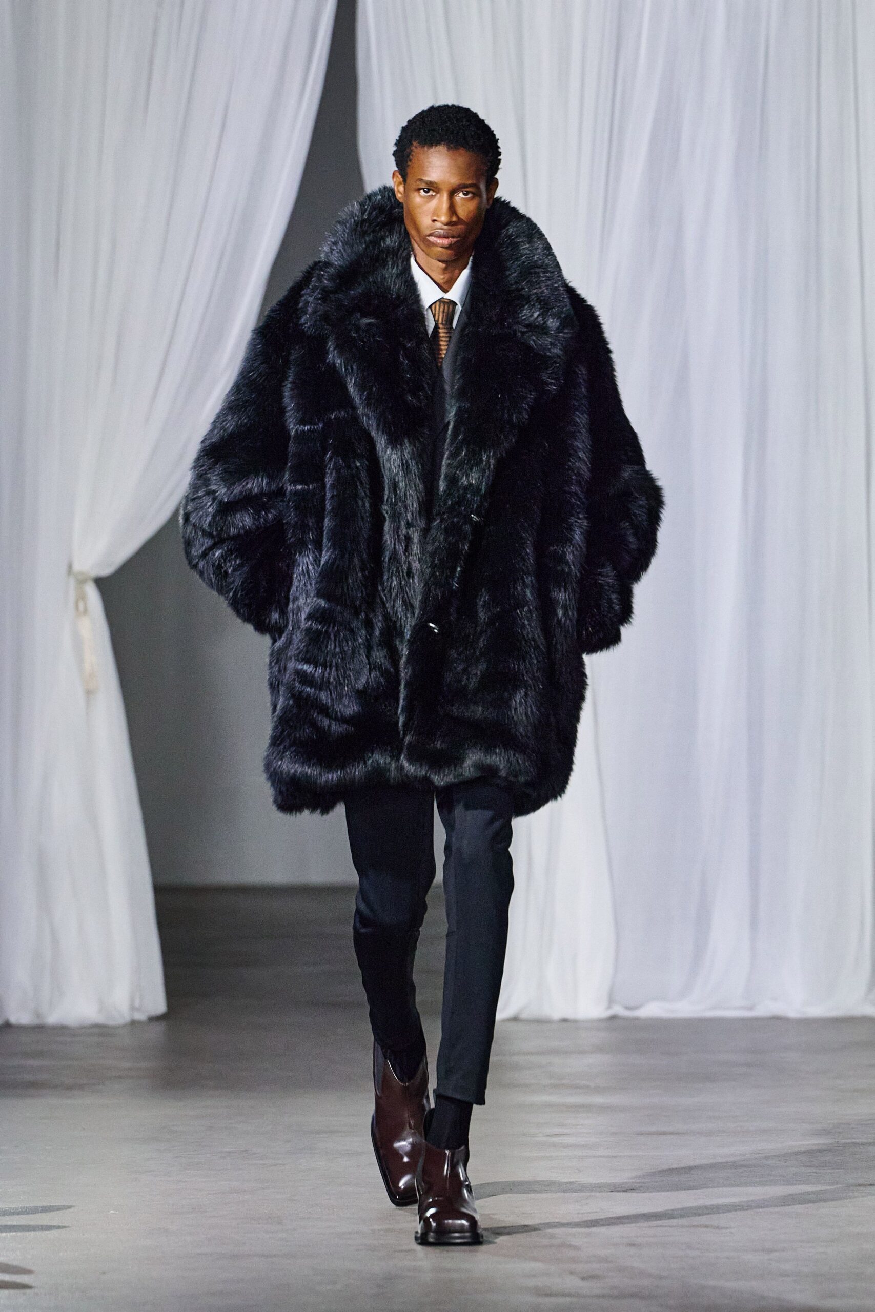 black faux-fur coat with slim pants