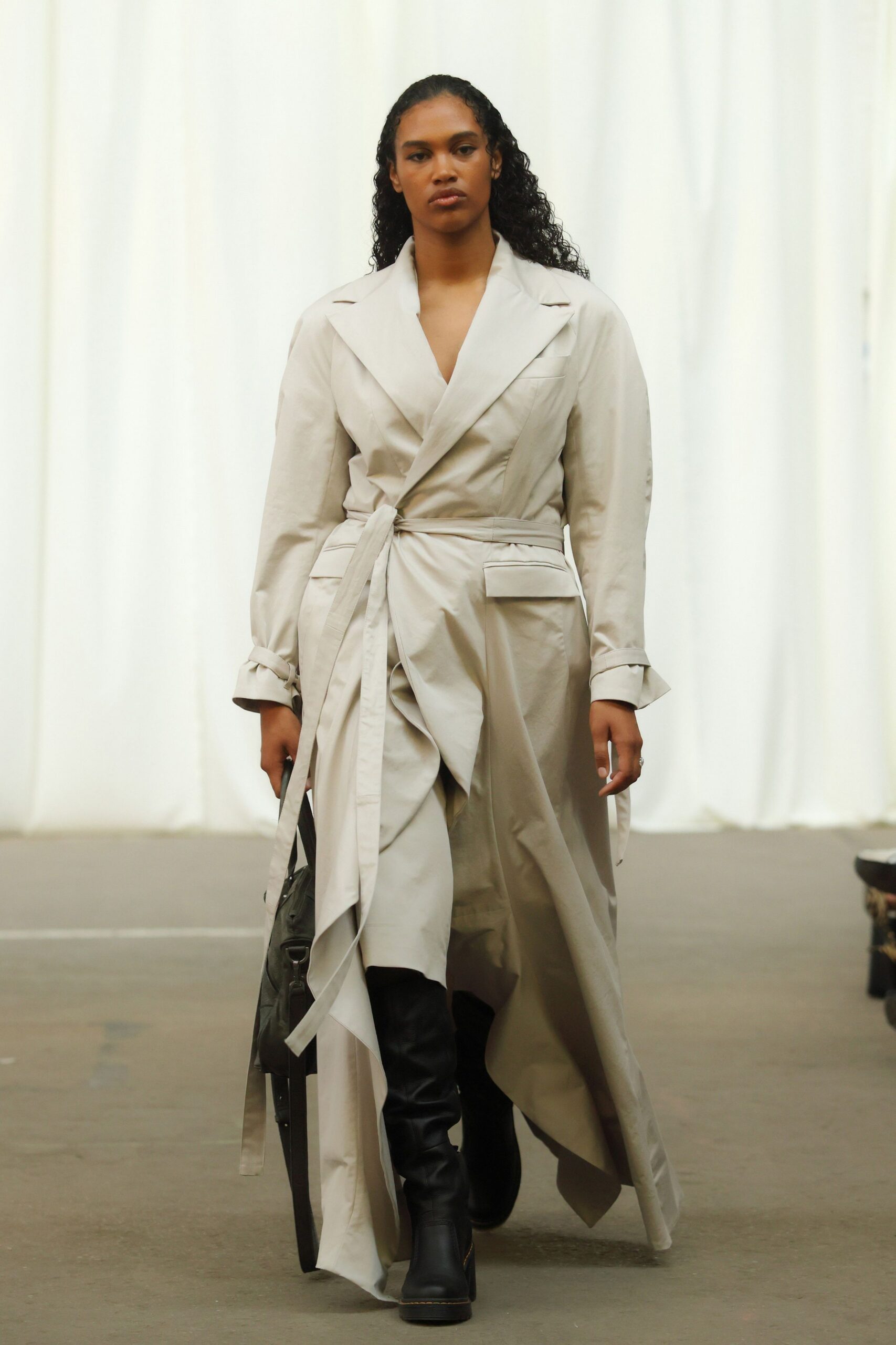 beige cotton relaxed trench coat with black boots