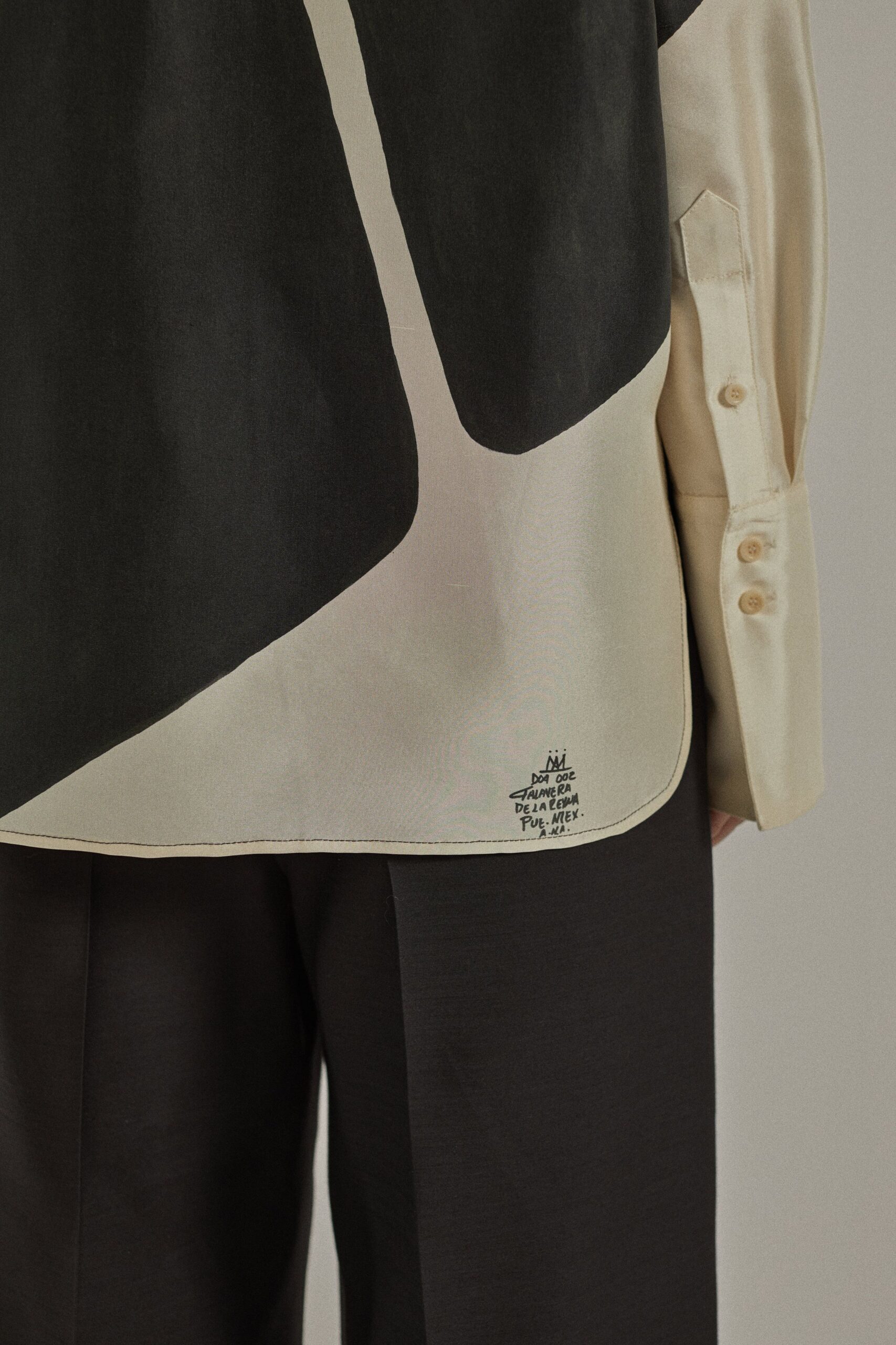 black and beige color-blocked shirt with tailored pants