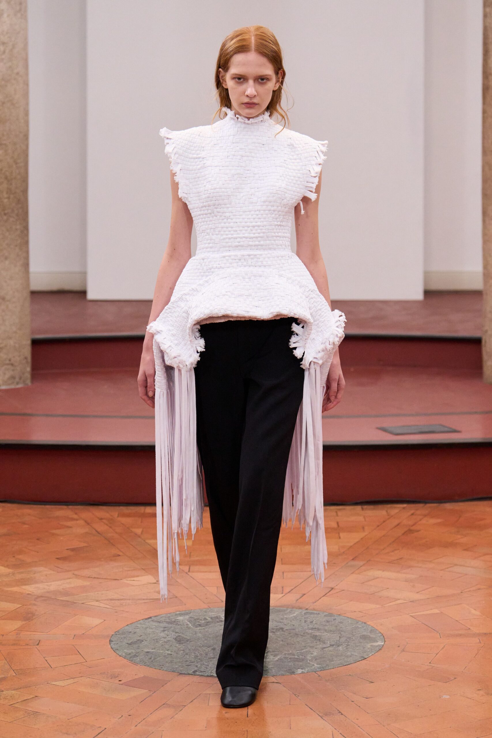 white fitted top with fringes and black pants