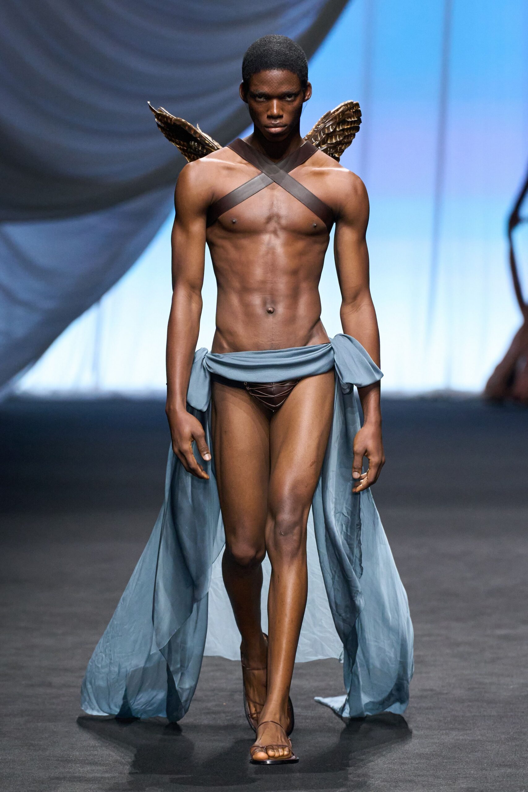 brown swimsuit with blue cape