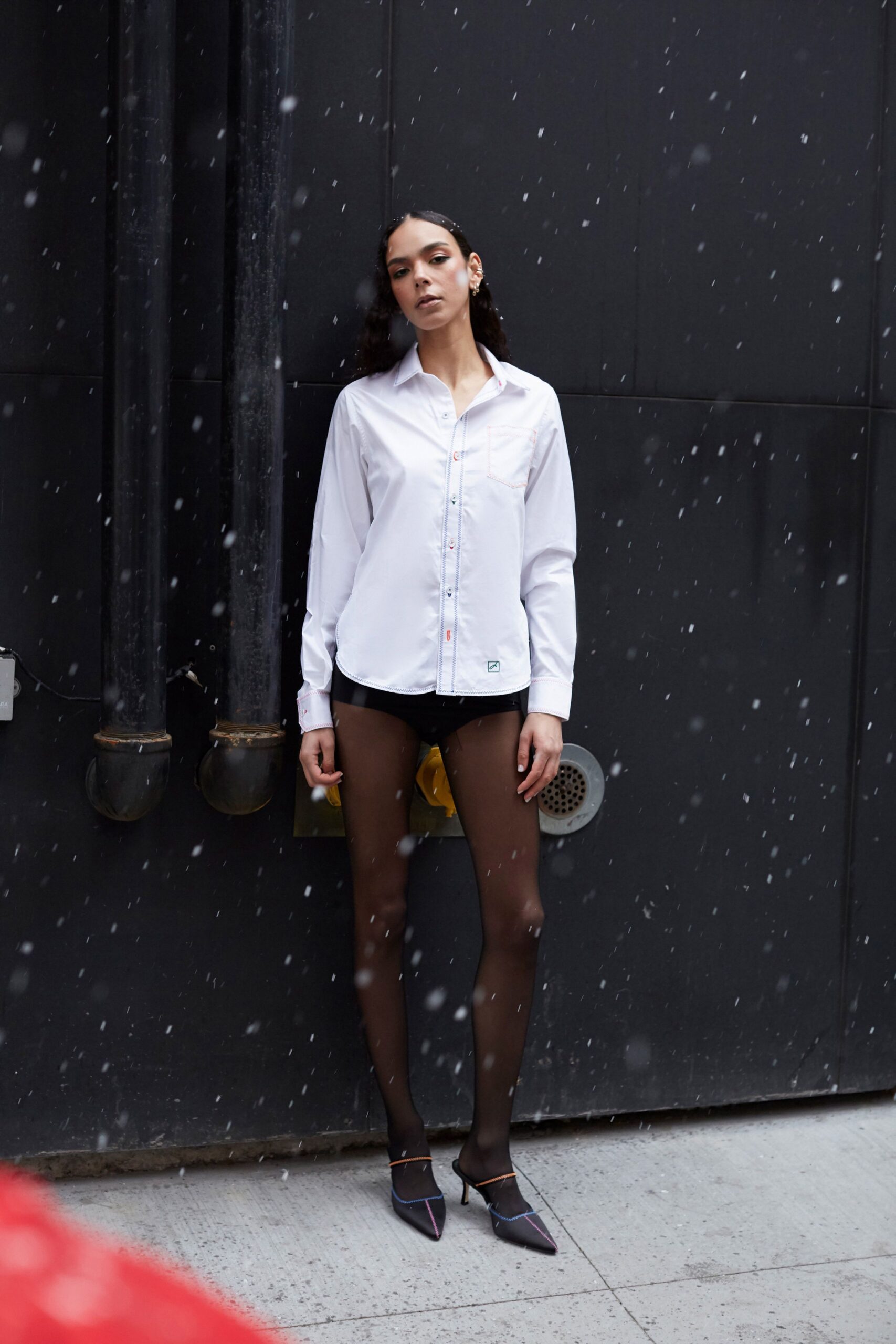 white fitted shirt with black shorts