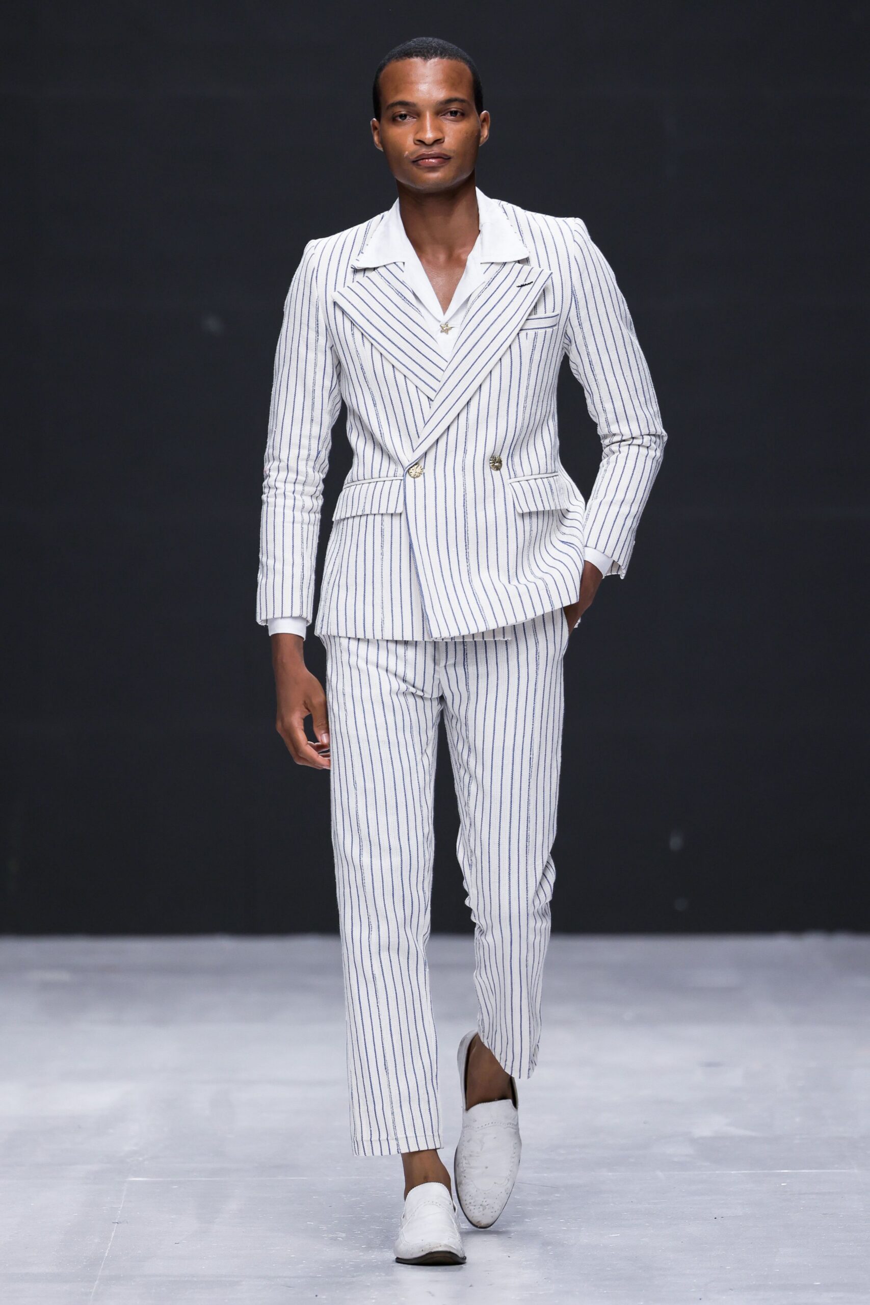 striped tailored suit with white shoes