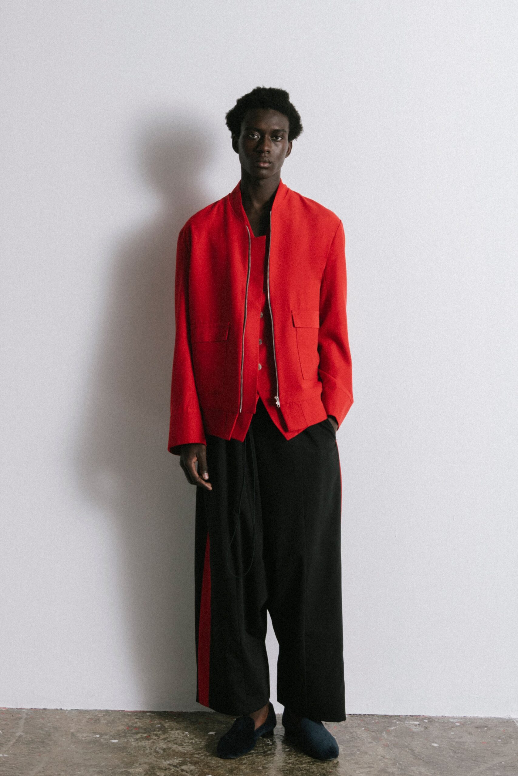 red jacket black shirt wide-leg pants