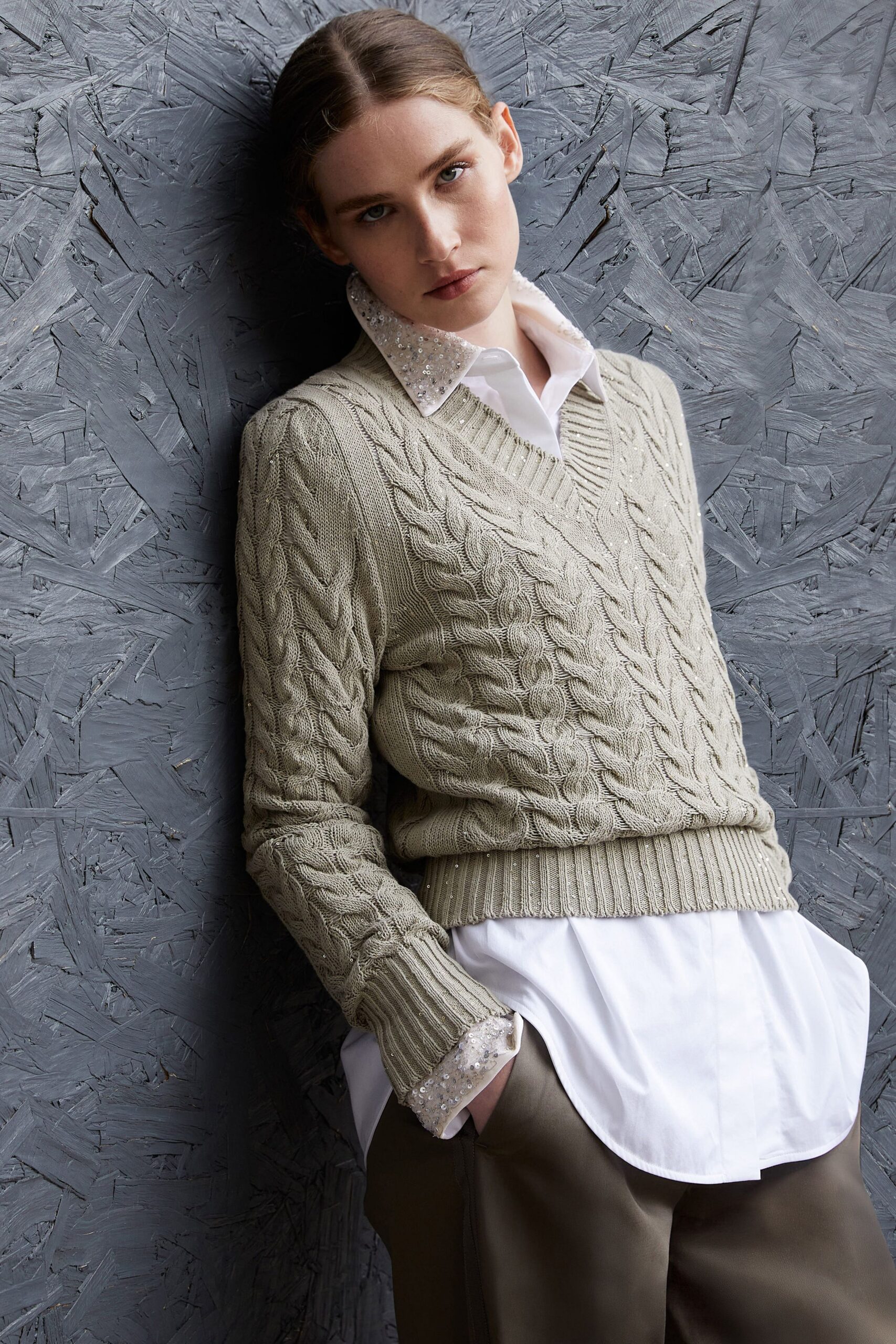beige cable-knit sweater with white shirt