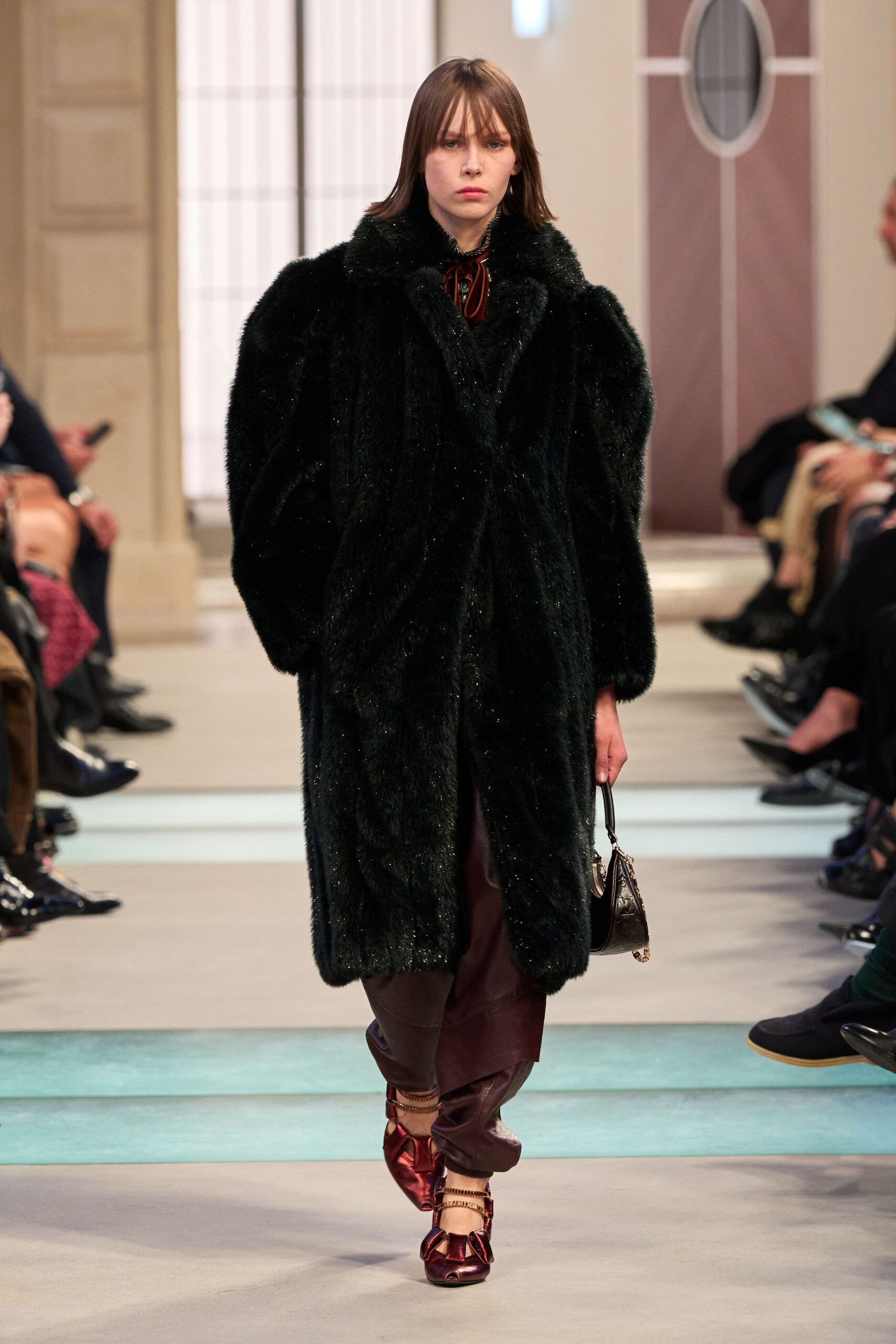 black faux-fur coat with brown silk pants