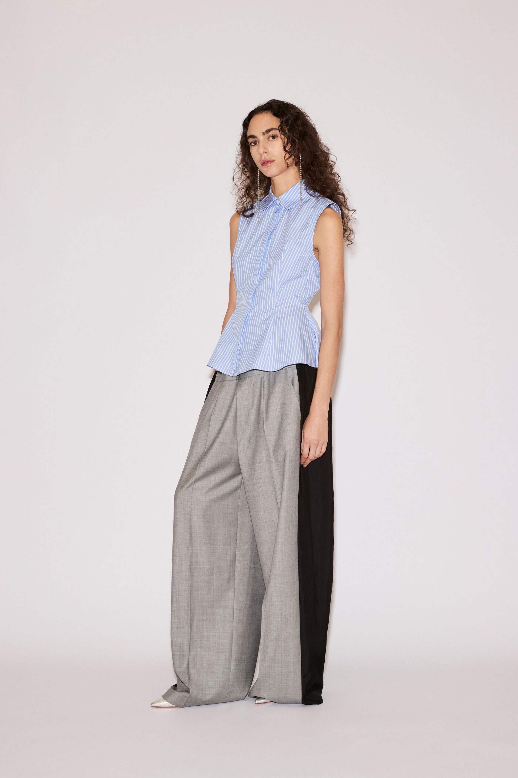 blue striped sleeveless shirt with gray pants