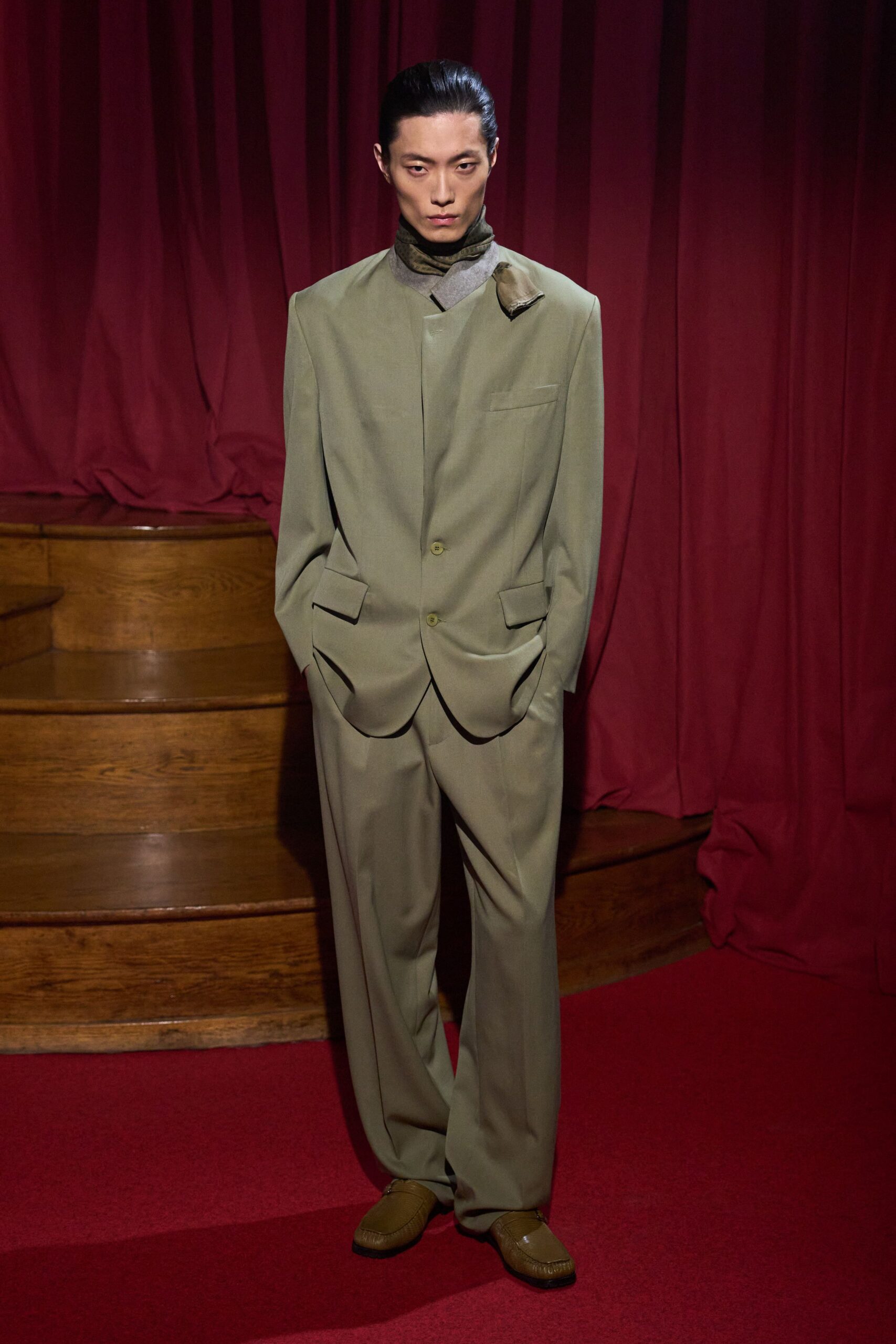 green relaxed suit with brown shoes