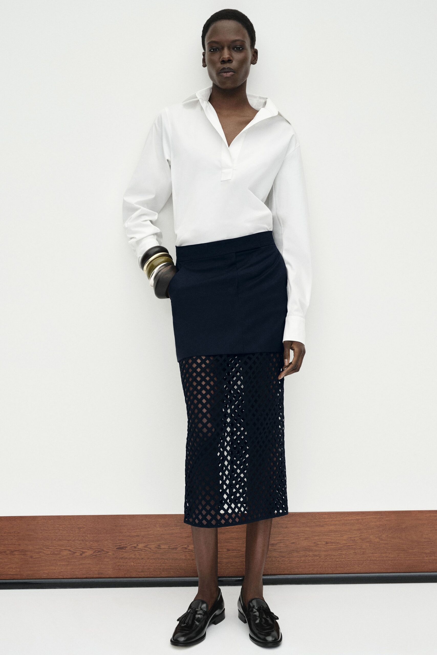 white fitted shirt with navy skirt