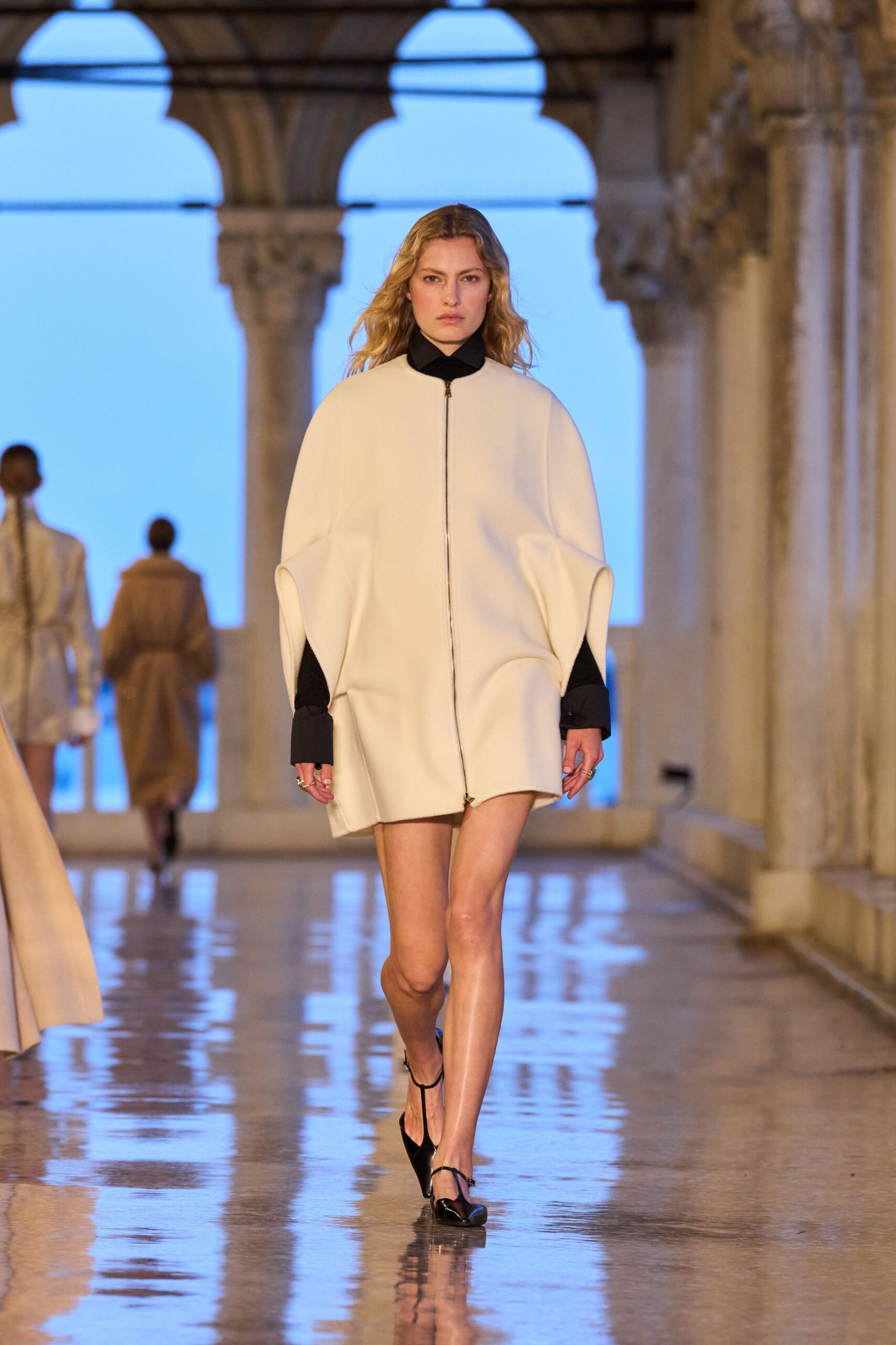 white relaxed coat with black shorts