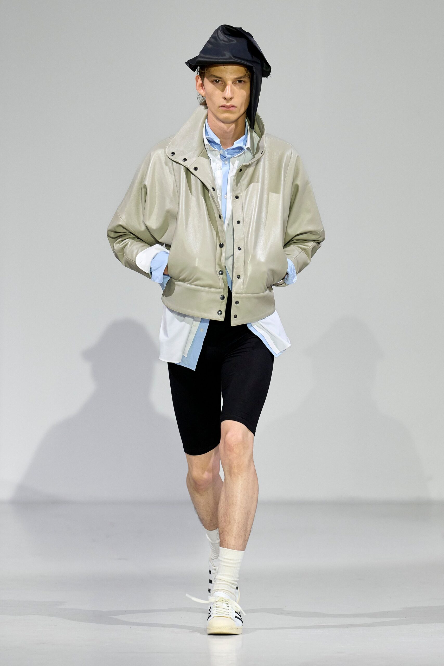 beige leather jacket with black shorts